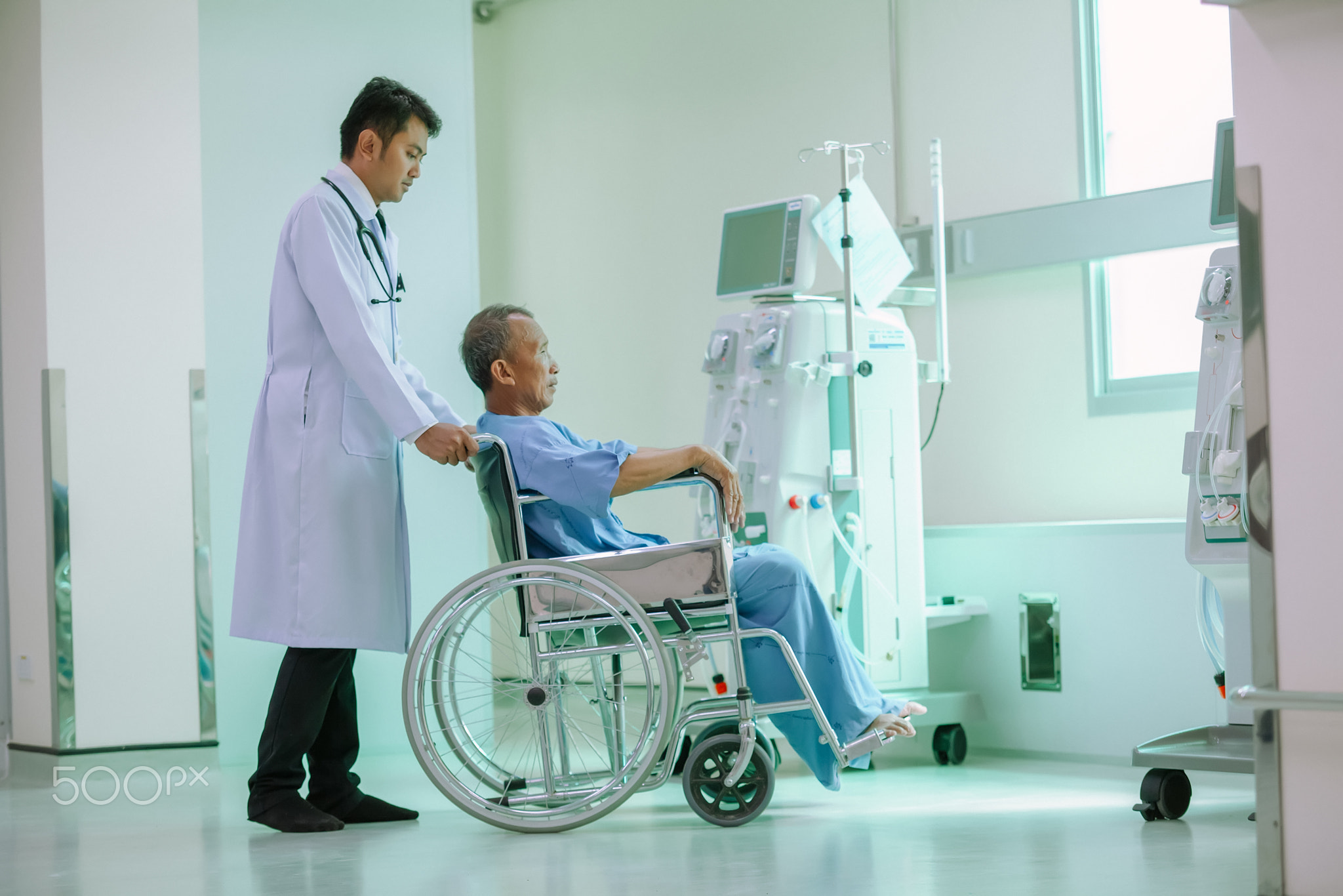 The doctor is taking care of senior patient in wheelchair,Commun