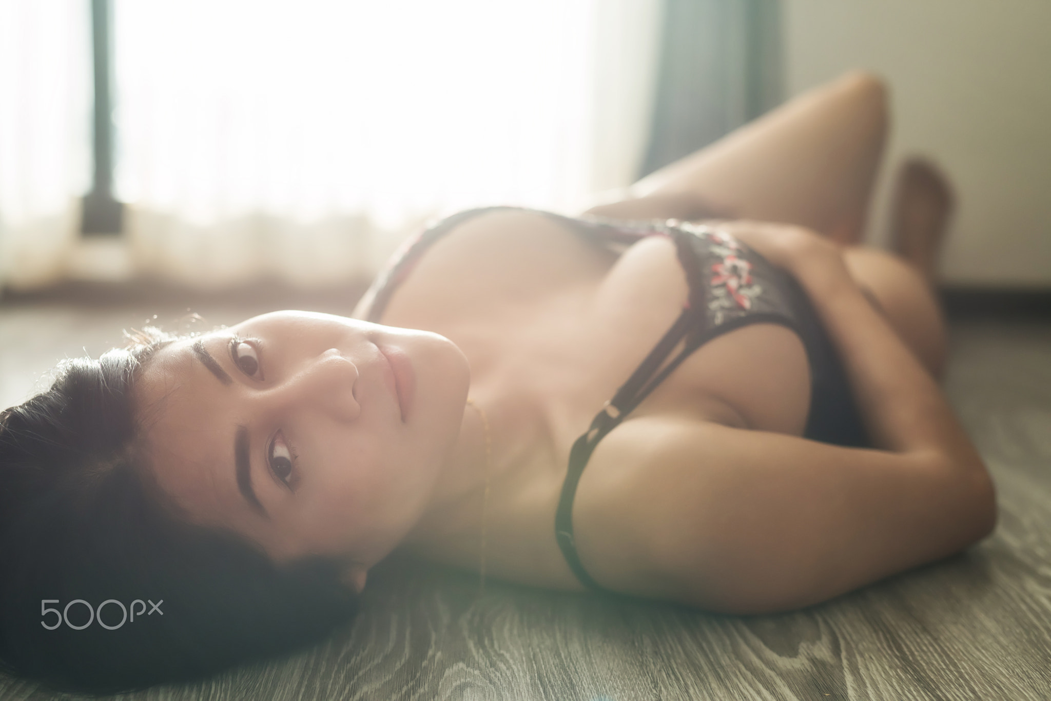 Sexy Asian woman with flare light in room