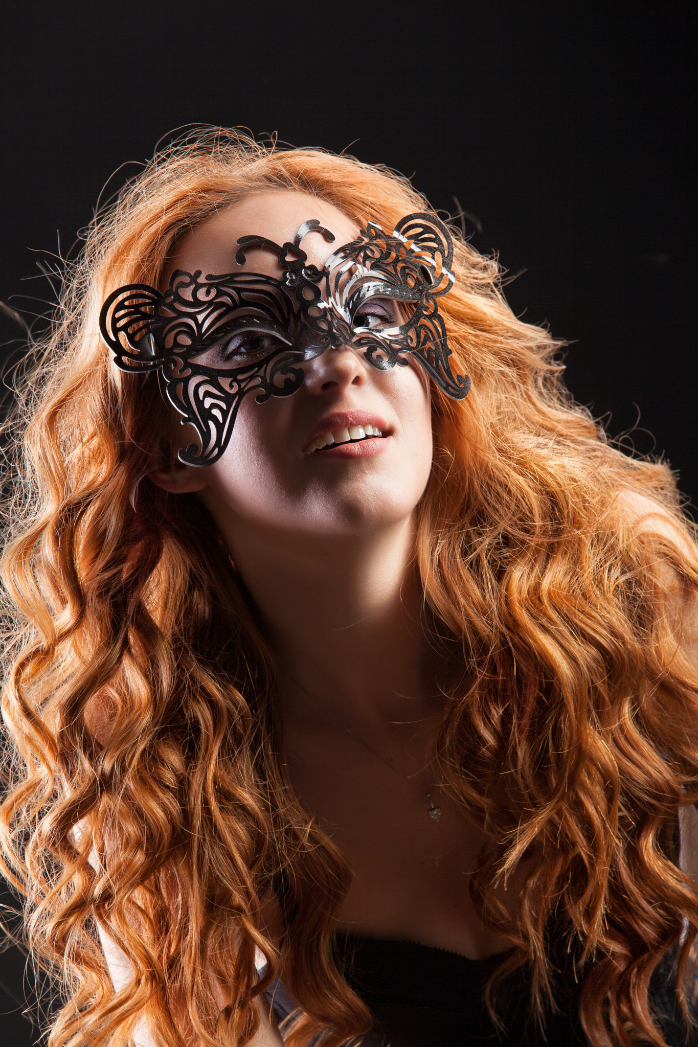 Young Red- Haired Woman In A Black Mask