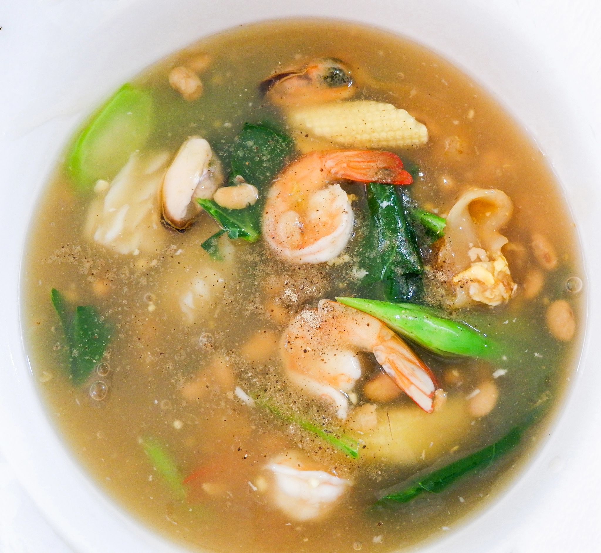 Fried noodle with seafood shrimp mussel pork and kale vegetable