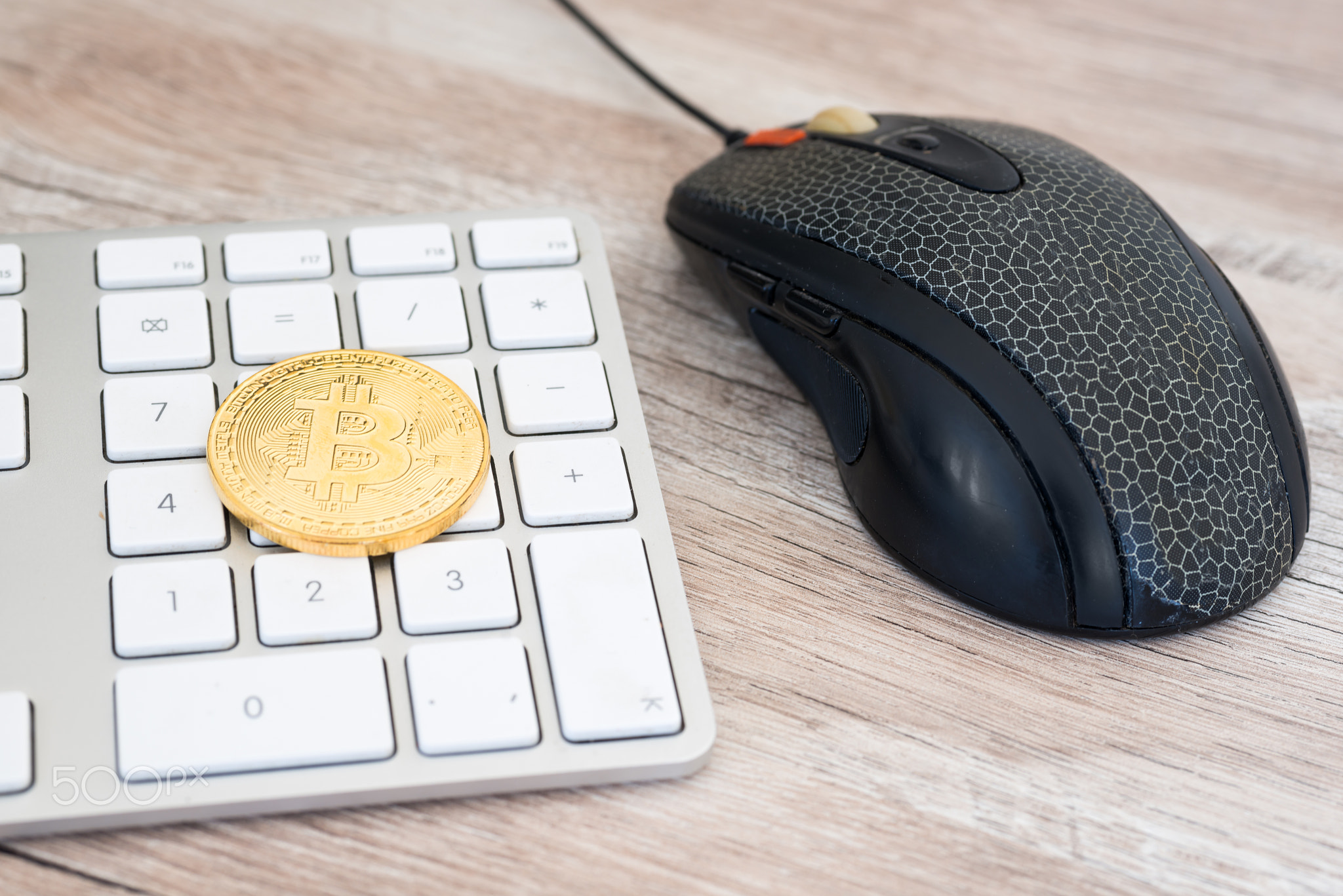 Golden bitcoin on a keyboard