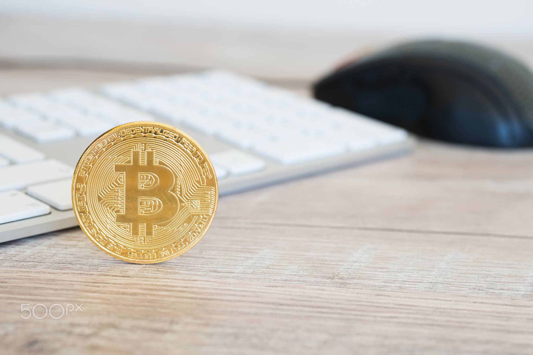 Golden bitcoin on a wooden desk