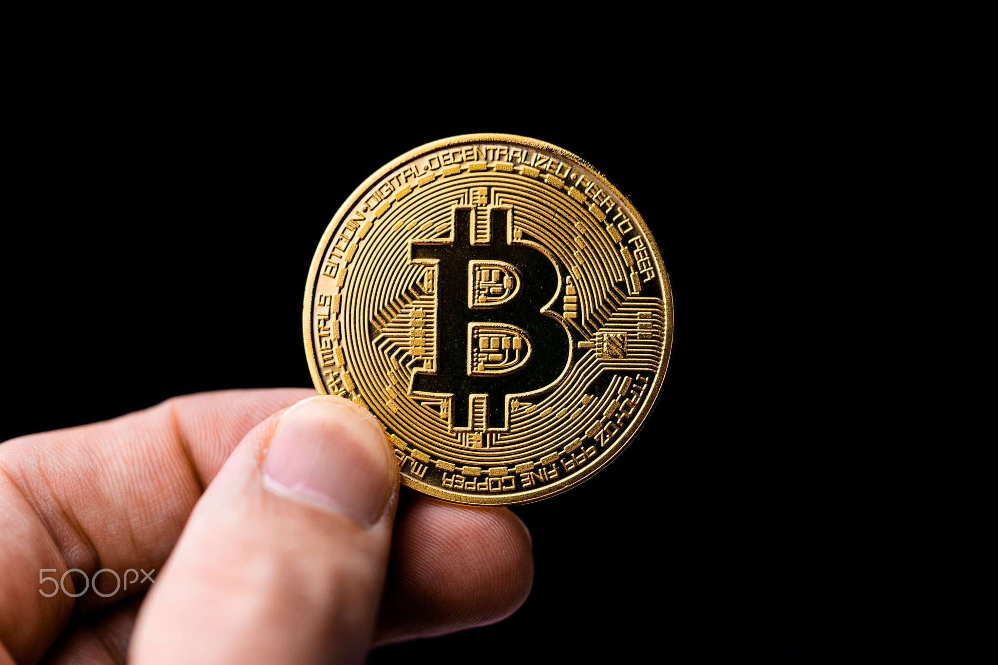 man holding a bitcoin coin