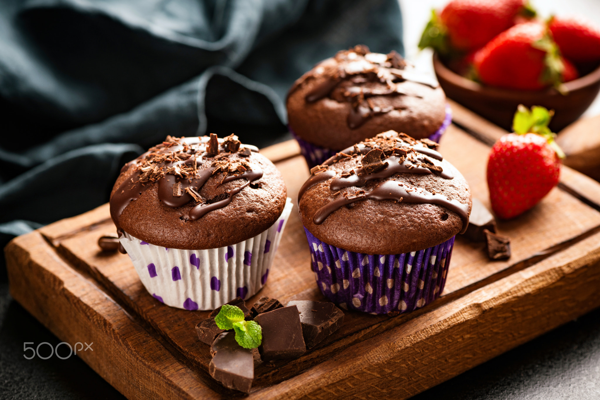 Chocolate muffins on wooden board