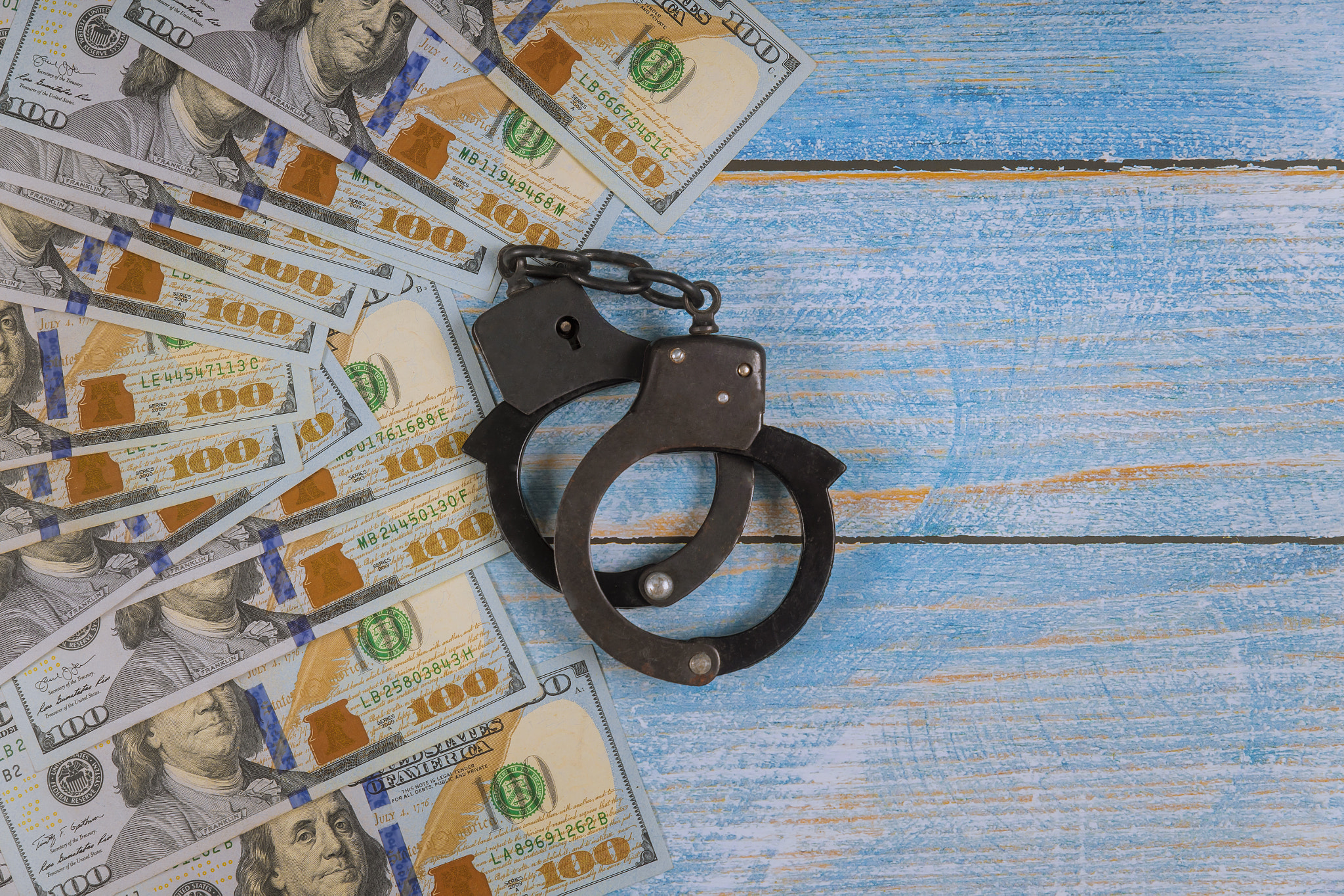 US dollar banknotes money cash corruption, dirty money financial crime of metal police handcuffs