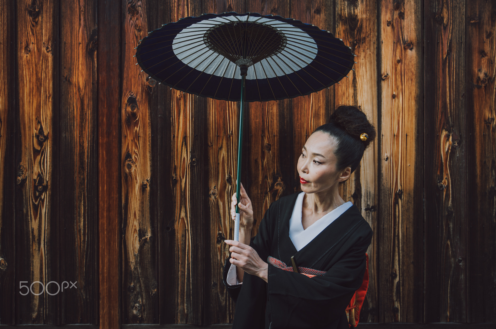 Beautiful japanese senior woman walking in the village. Typical