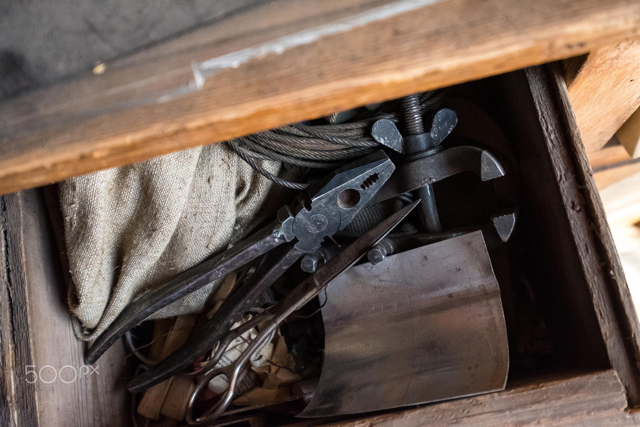 Old tools in a wooden chest of drawers