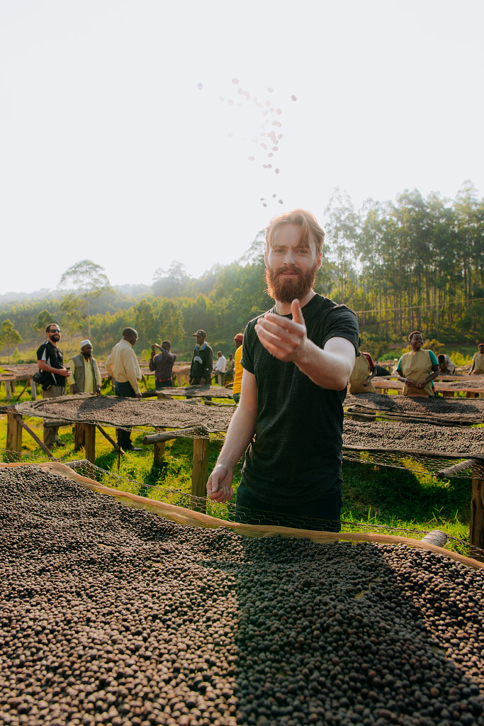 Man throwing coffee beans in the air in Rwanda by Aidan Campbell on 500px.com