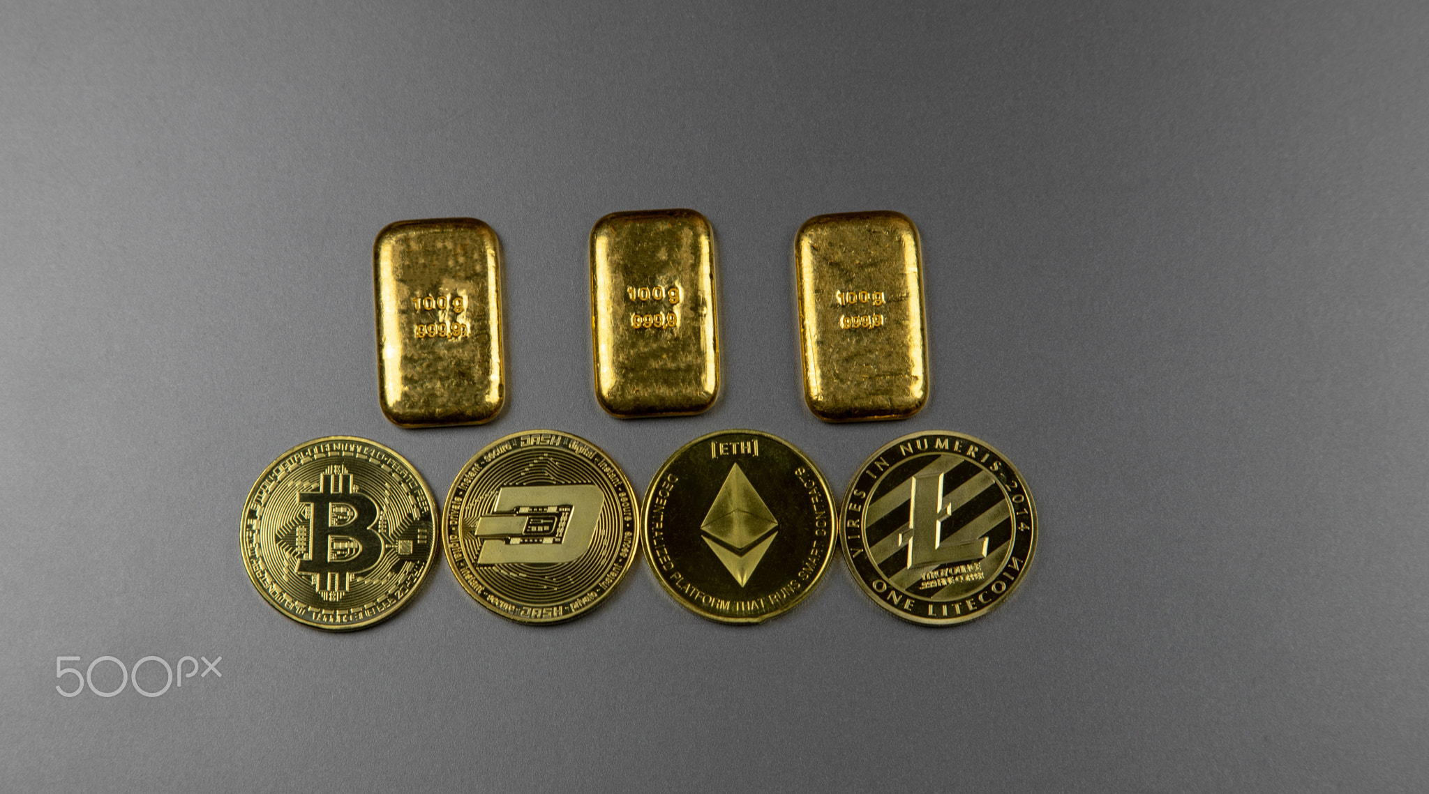 Gold bars and cryptocurrency coins, concept of electronic currencies.