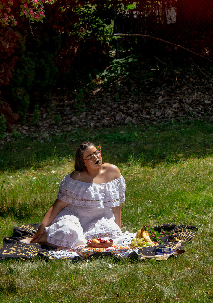 Young lady basking in sun with basket of fruits. by Hagar Wirba on 500px.com