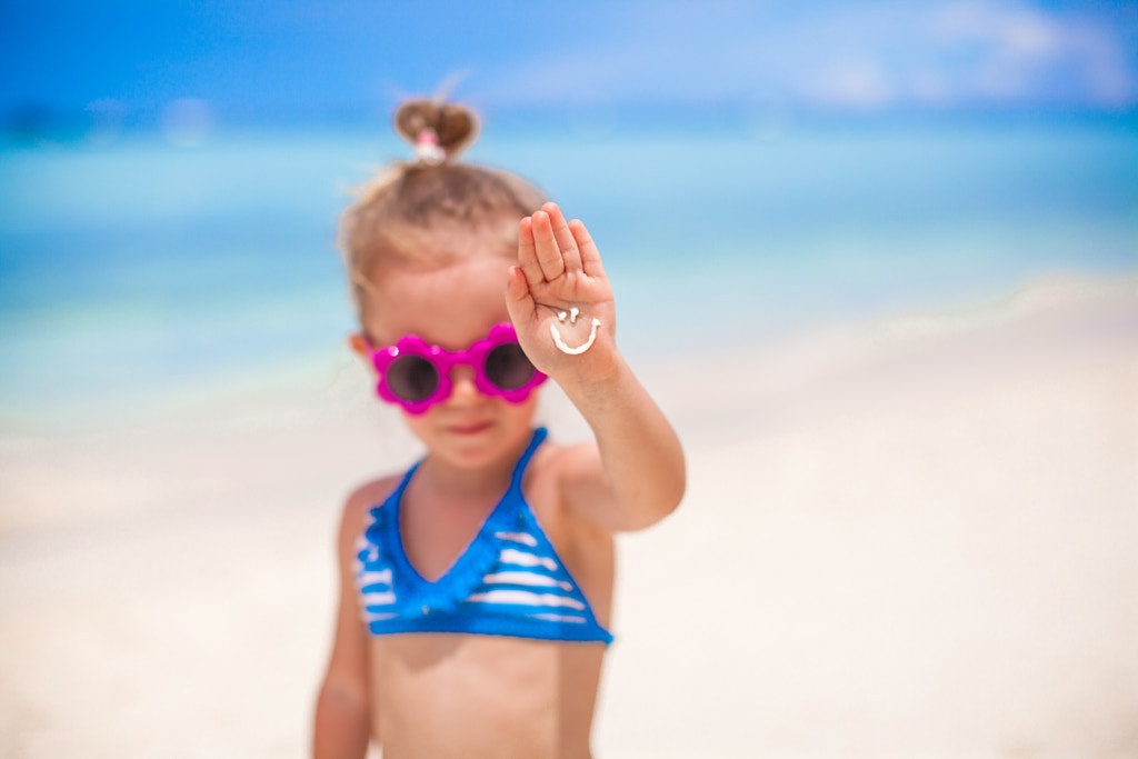 Close-up of smile made by sun cream ​​on palm little girl by Dmitry Travnikov on 500px.com