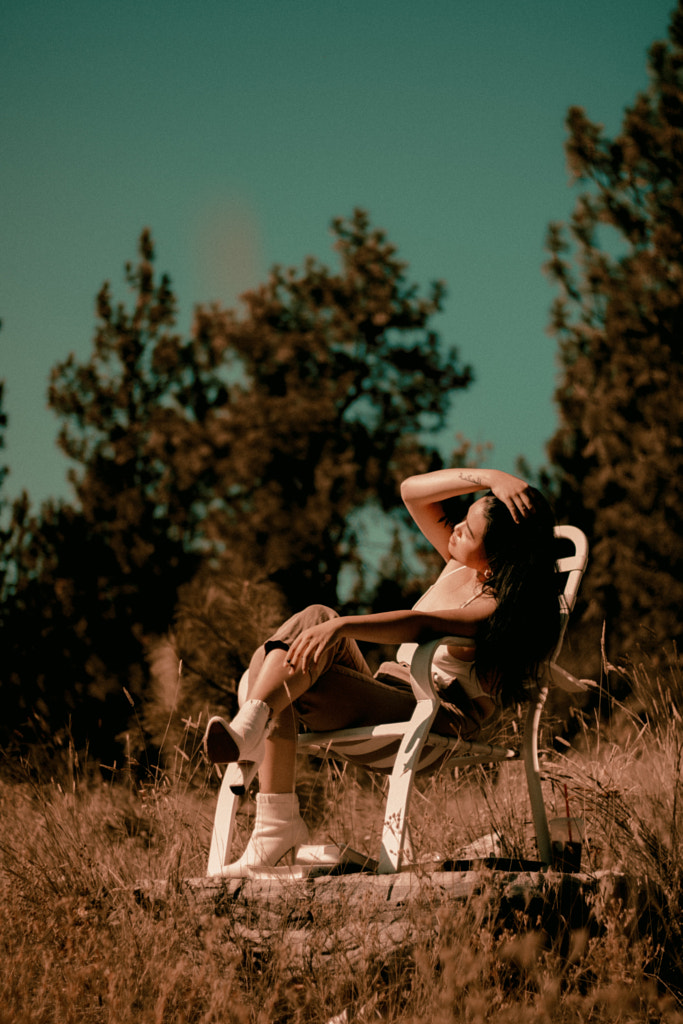 Young Asian woman relaxing on a chair in the woods with joint in hand by Hagar Wirba on 500px.com