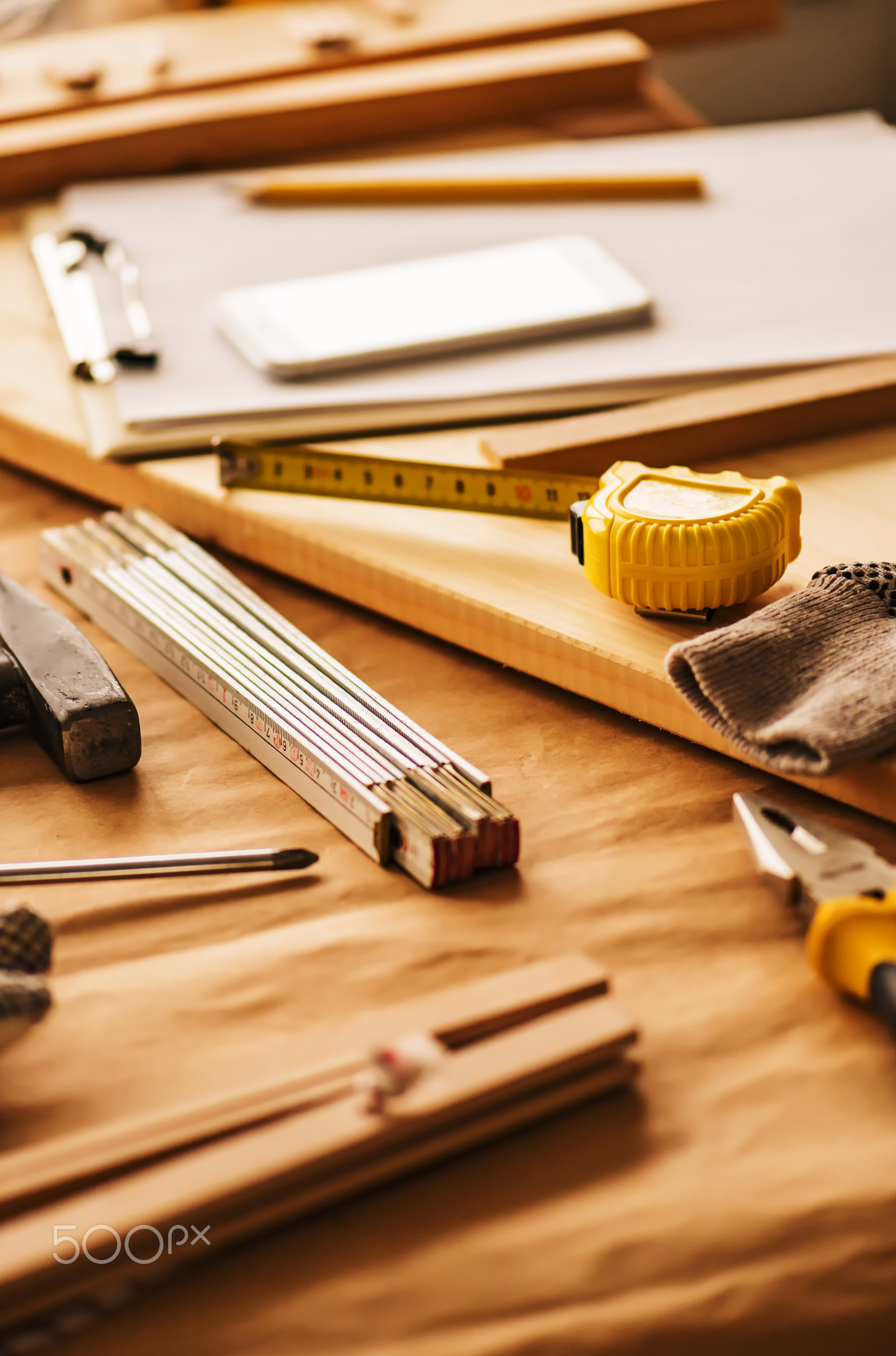 Various tools on carpentry woodwork workshop desk, selective foc