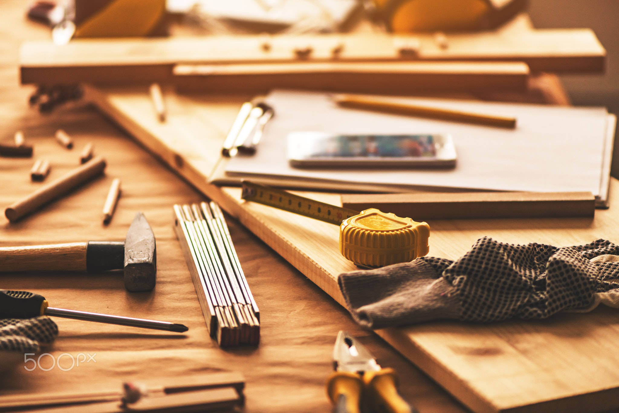 Various tools on carpentry woodwork workshop desk, selective foc