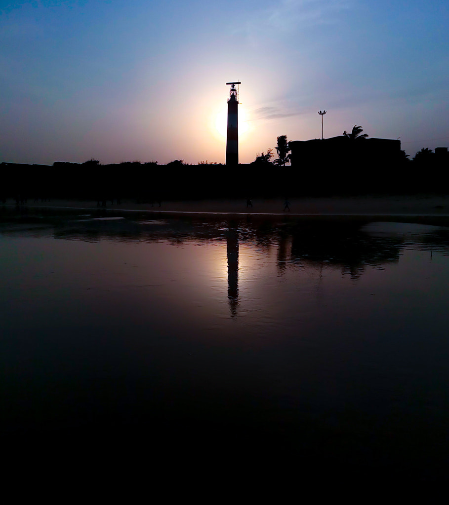 Wallpaper photograph of the beautiful vibrant reflective Sunset during the evening and the sun down behind the light house at the gopalpur sea beach barampur odisha india captured by Jayashankar Majhi on 500px.com