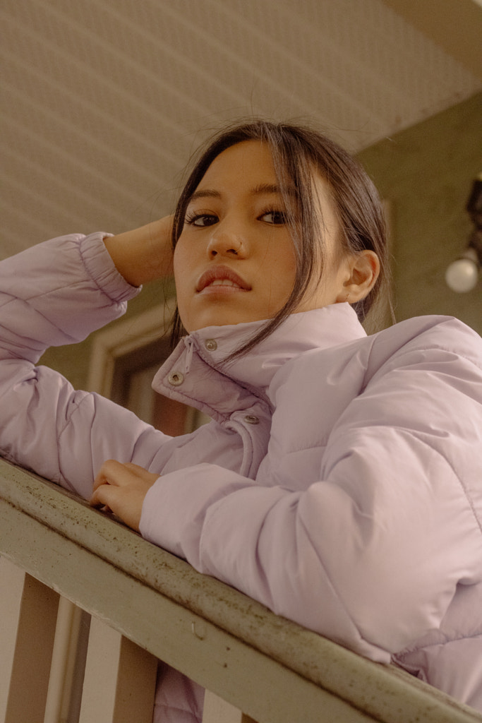 Young Asian woman leaning on porch outdoors by Hagar Wirba on 500px.com