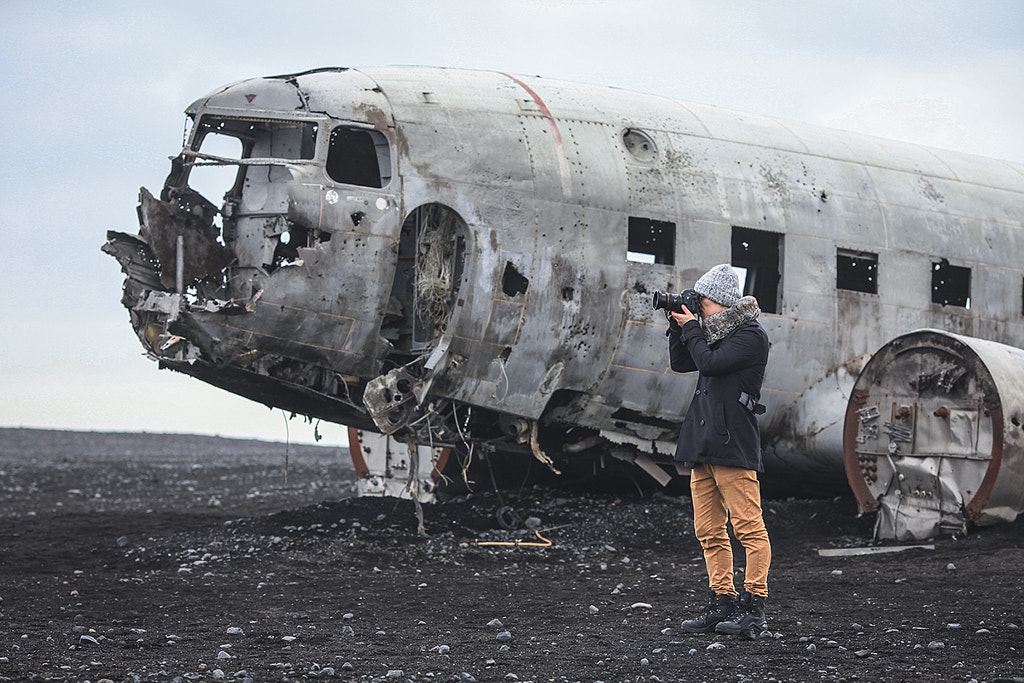Photographer on beach with Plane Wreck, Iceland by Lingxiao Xie on 500px.com