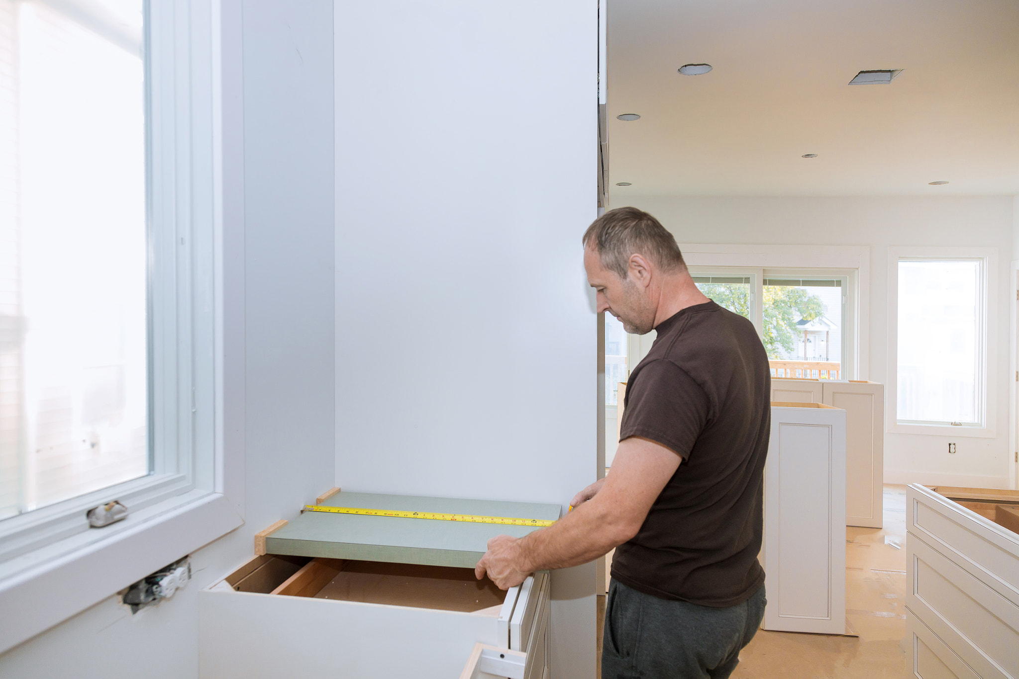 Installing contractors a laminate counter top a kitchen remodel.