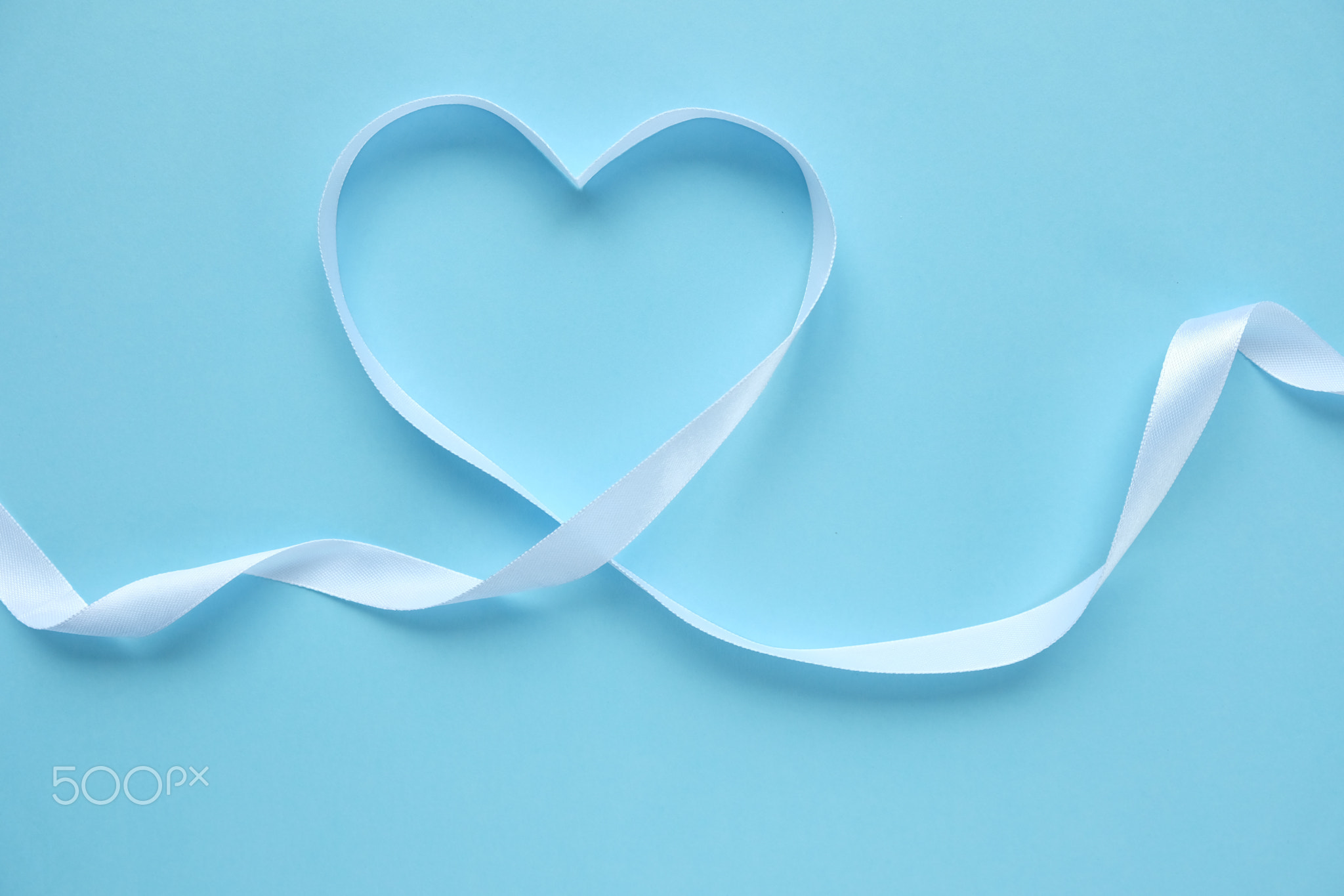 white ribbon in the shape of a heart