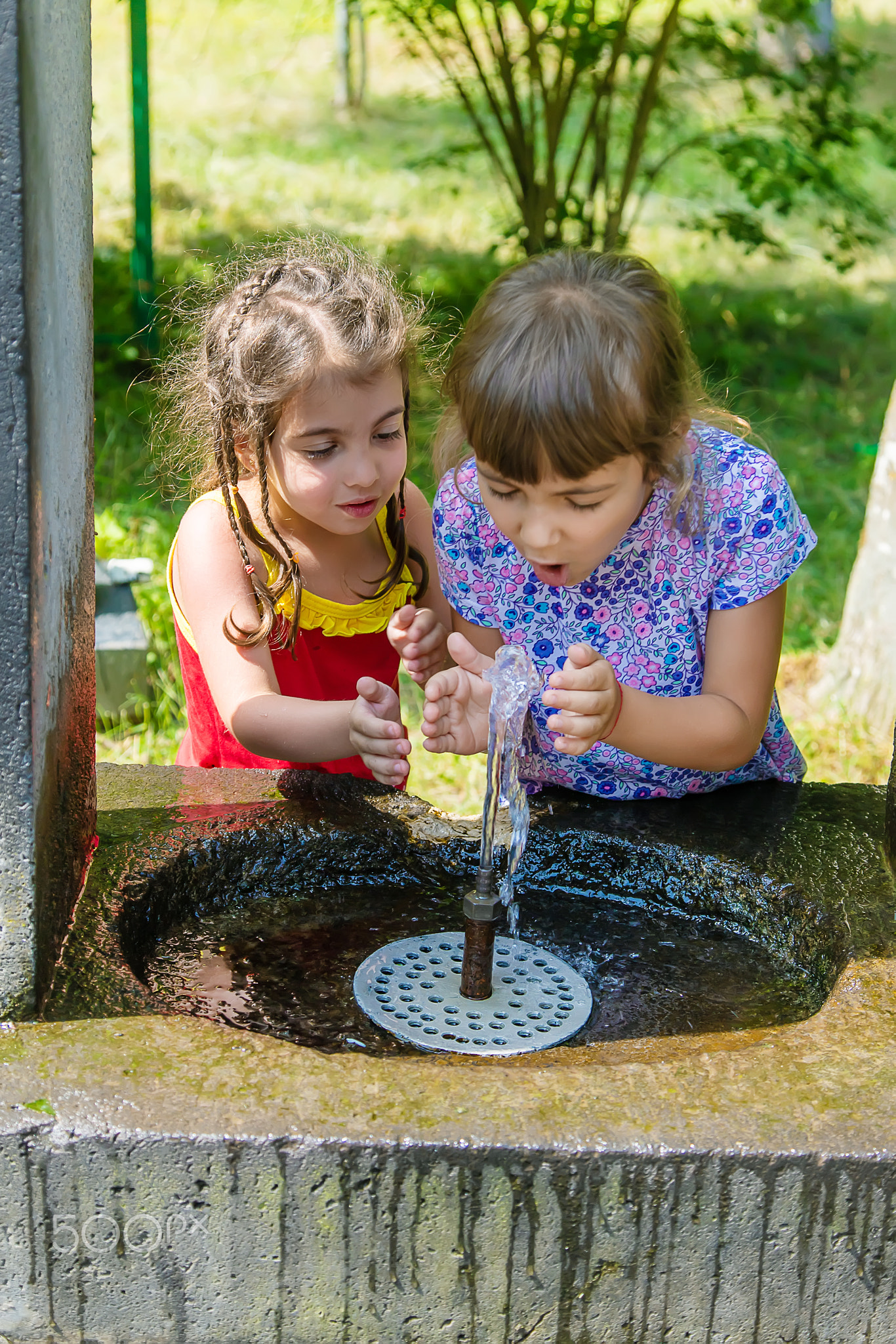 children drink water from a spring in Borjomi, Georgia. Selective focus.