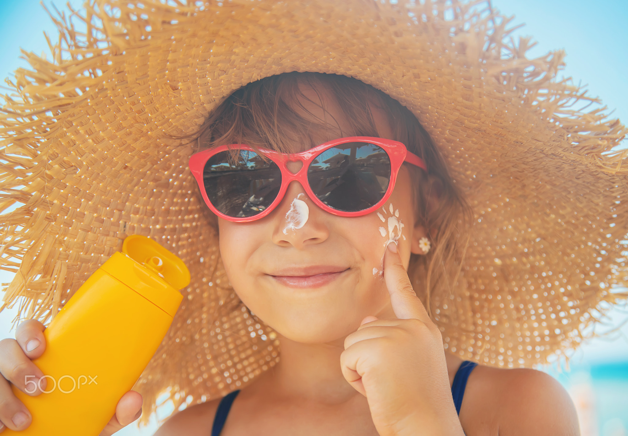 Sunscreen on the skin of a child. Selective focus.