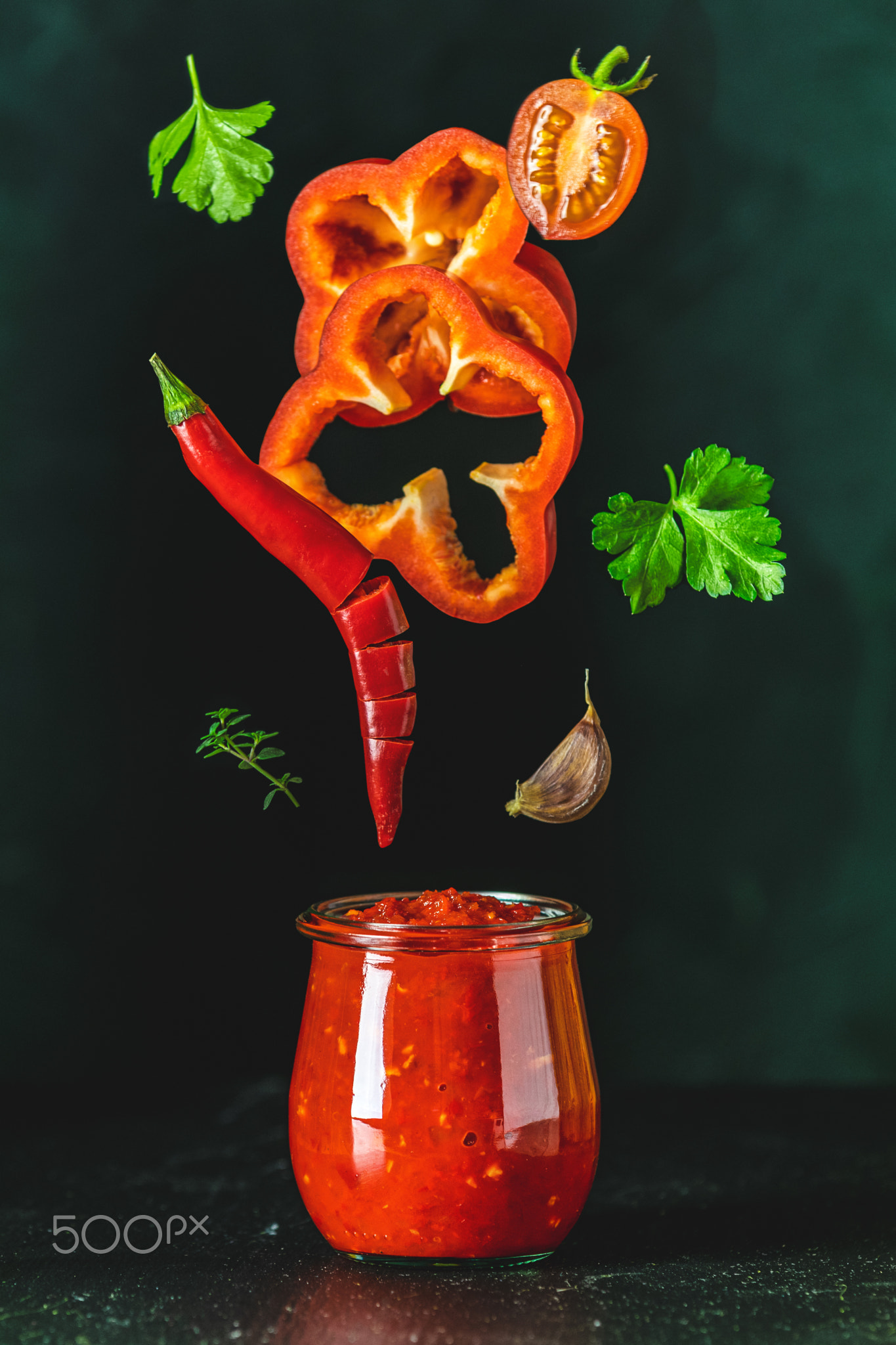 Sauce components frozen in the air. Homemade tomato sauce chutne