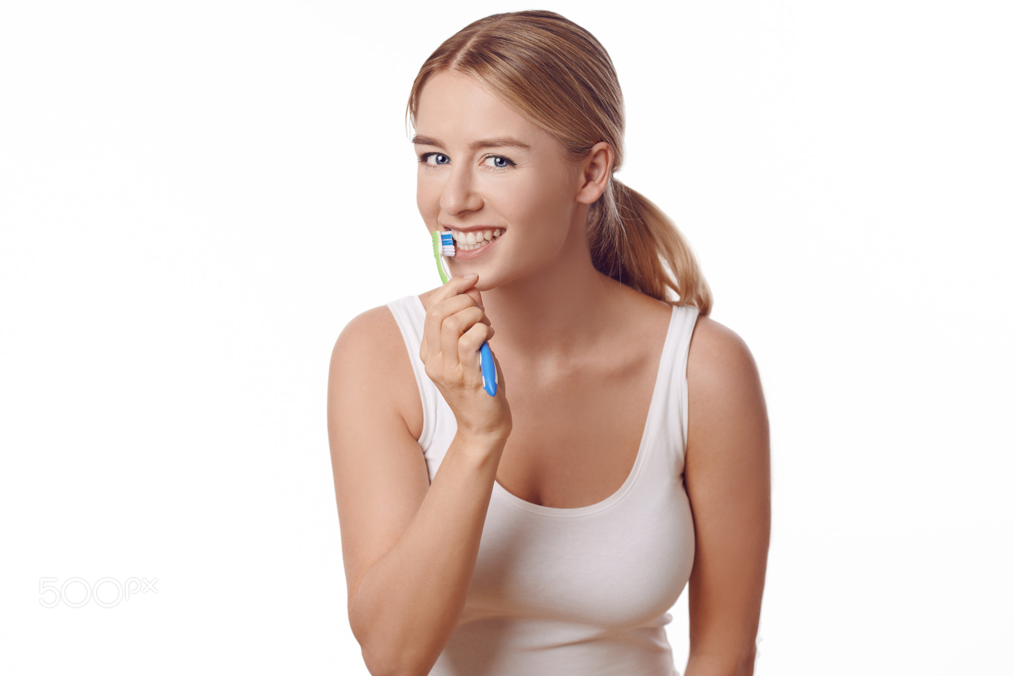 Attractive woman practicing dental hygiene