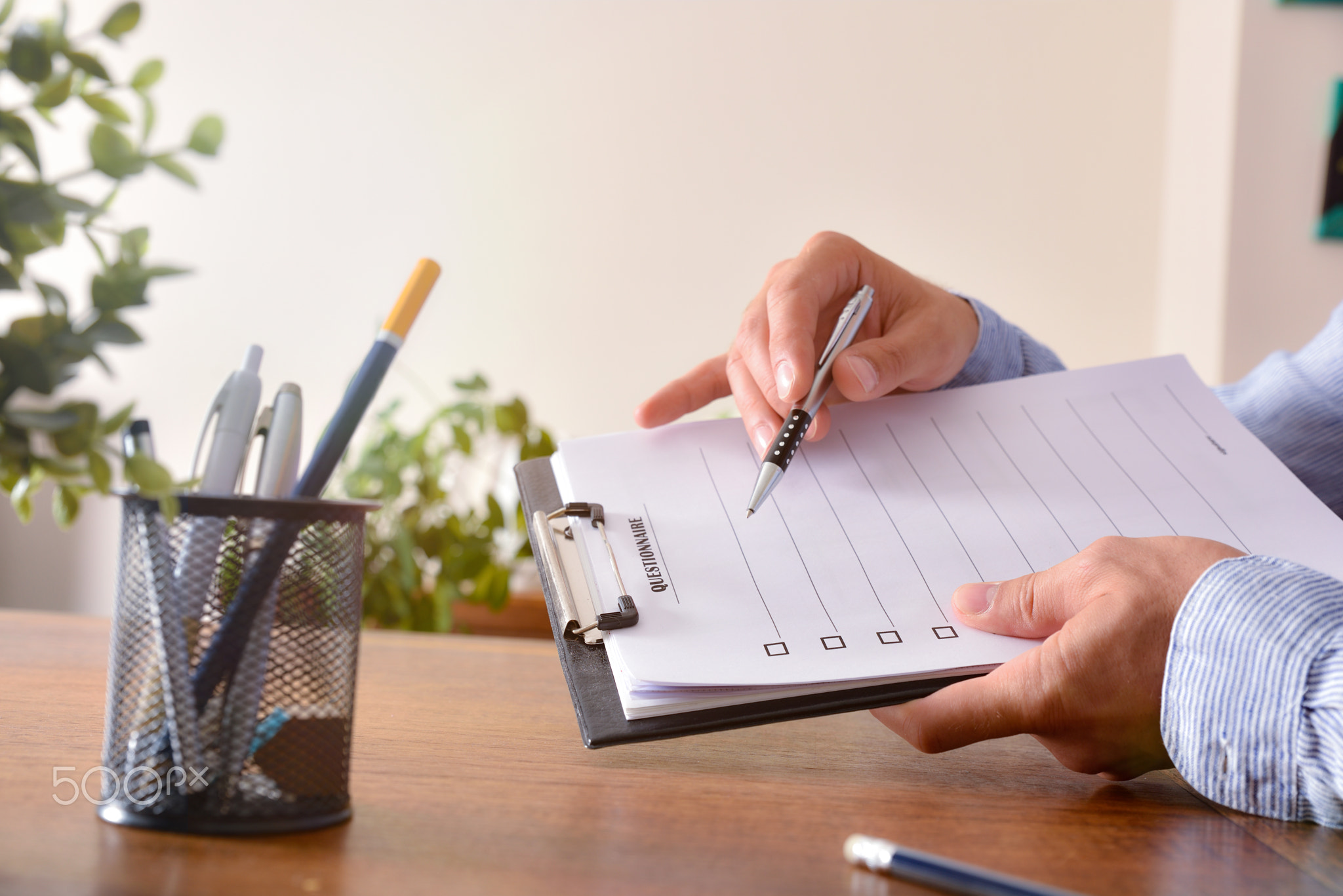 Smiling man  showing a questionnaire lateral view