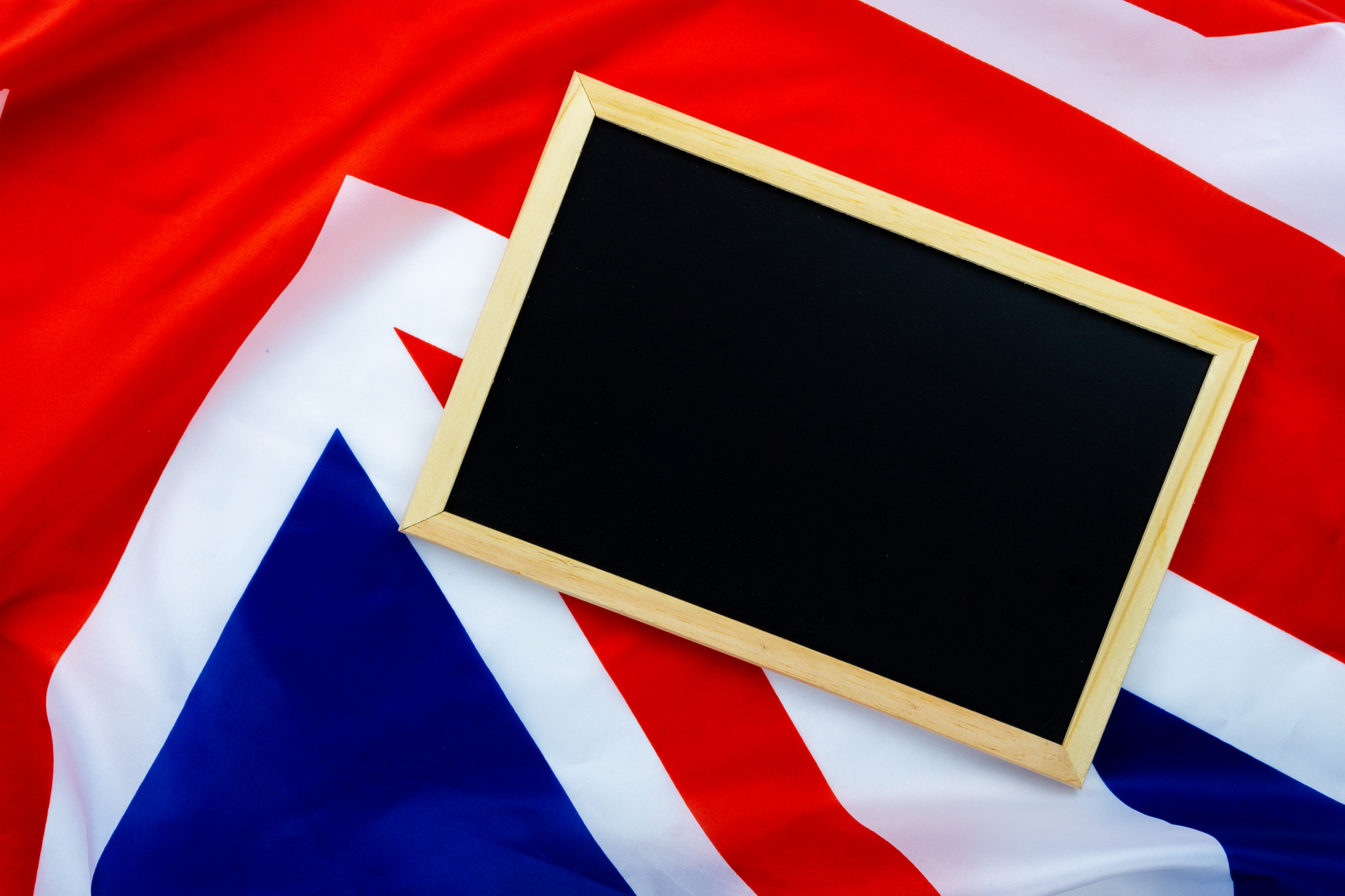 Flag of UK, British flag with blackboard, close up. Top view, co