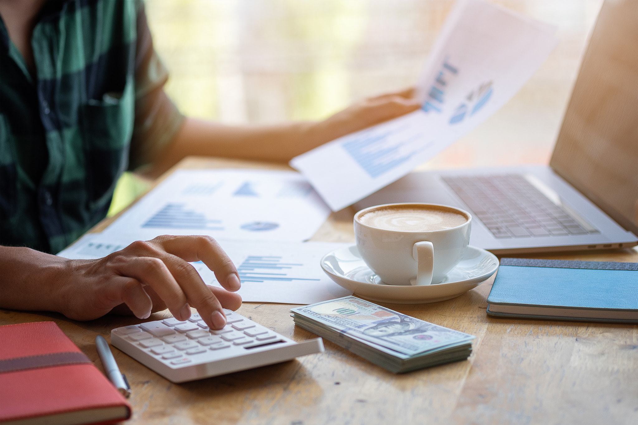 Man use calculator to calculate, Modern working life, Working in coworking space, Work in morning wi