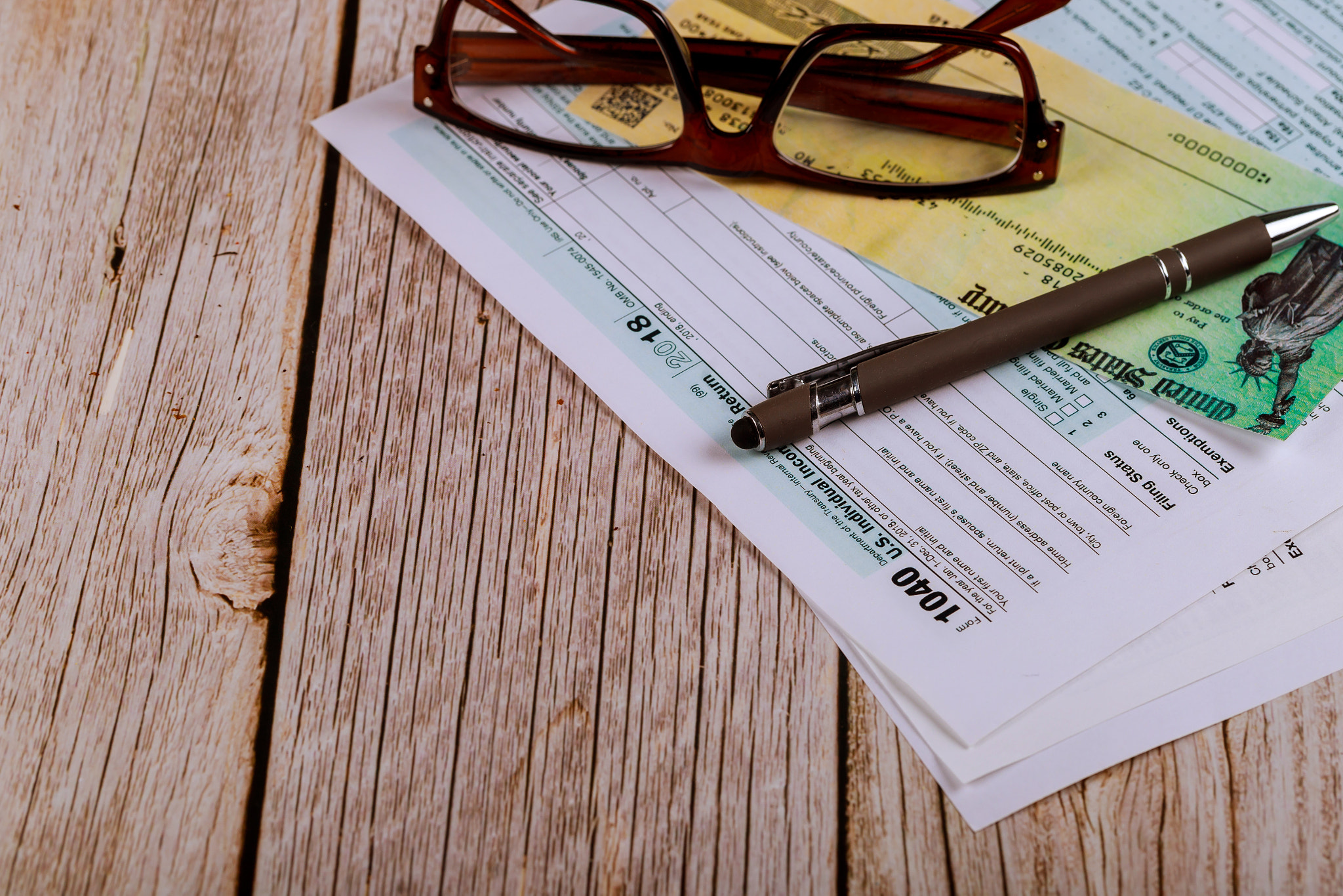 USA 1040 Tax Form with glasses an financial office