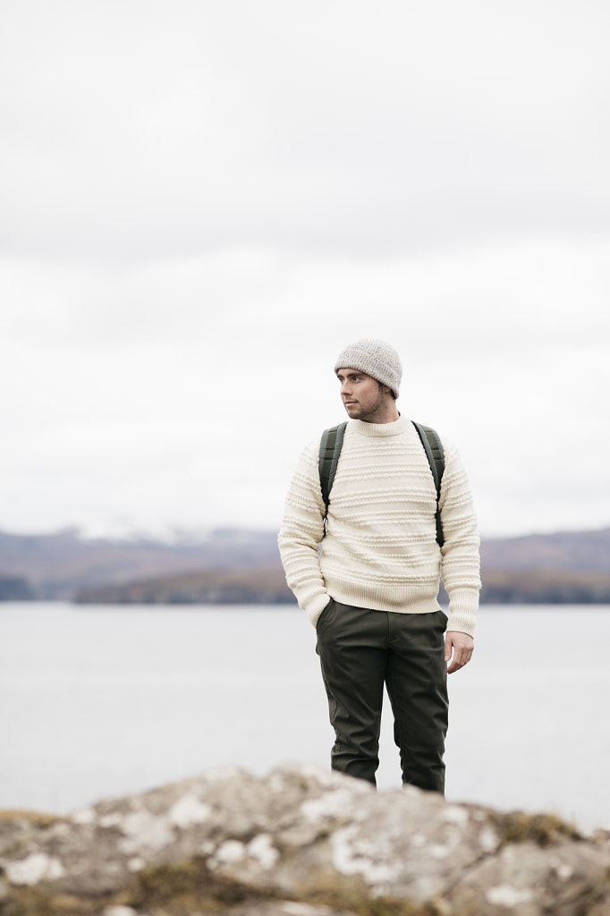 Man standing overlooking ocean and snowy mountains by Cameron Prentice on 500px.com