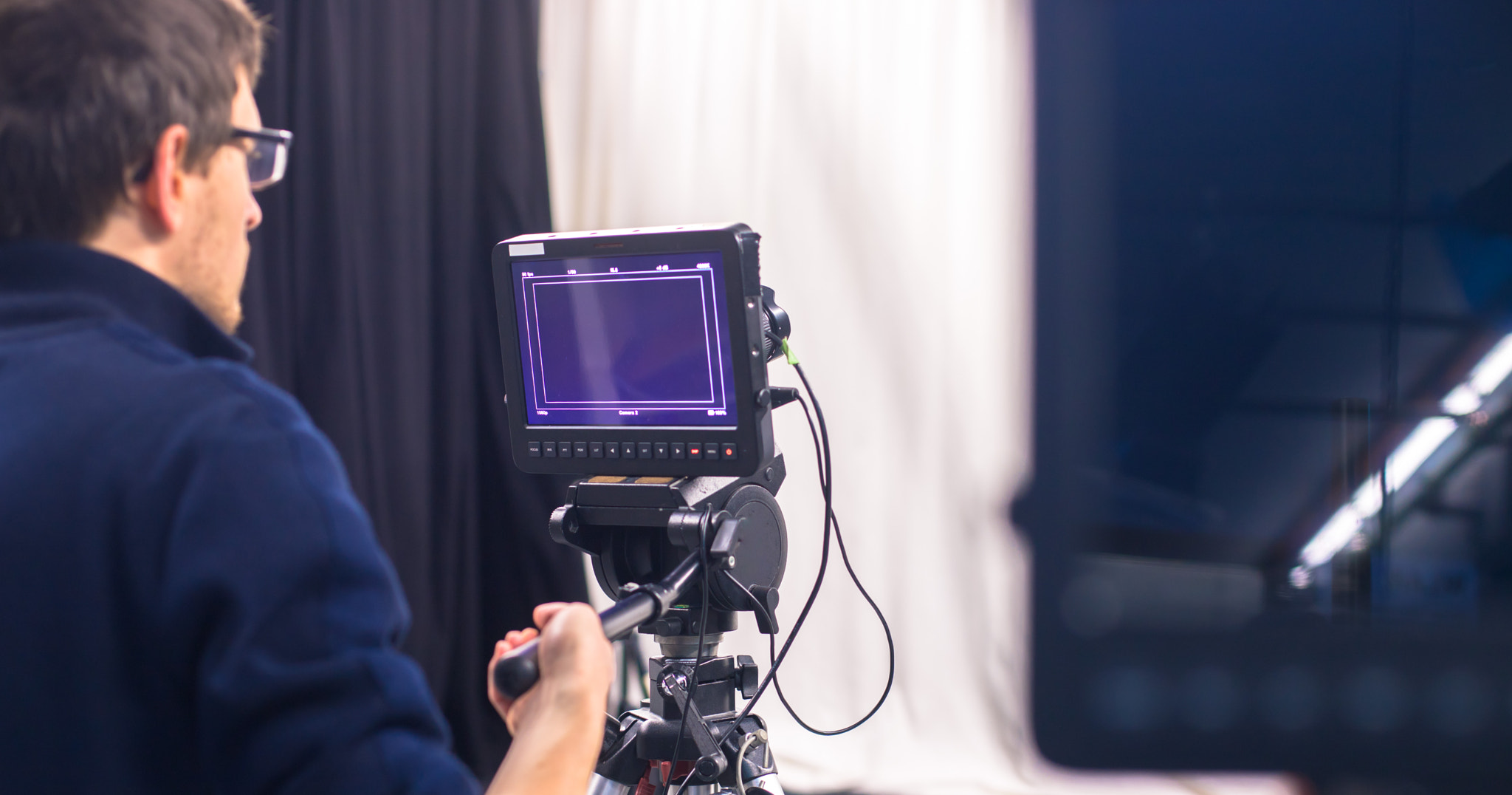 Cameraman operates a film camera, broadcasting studio