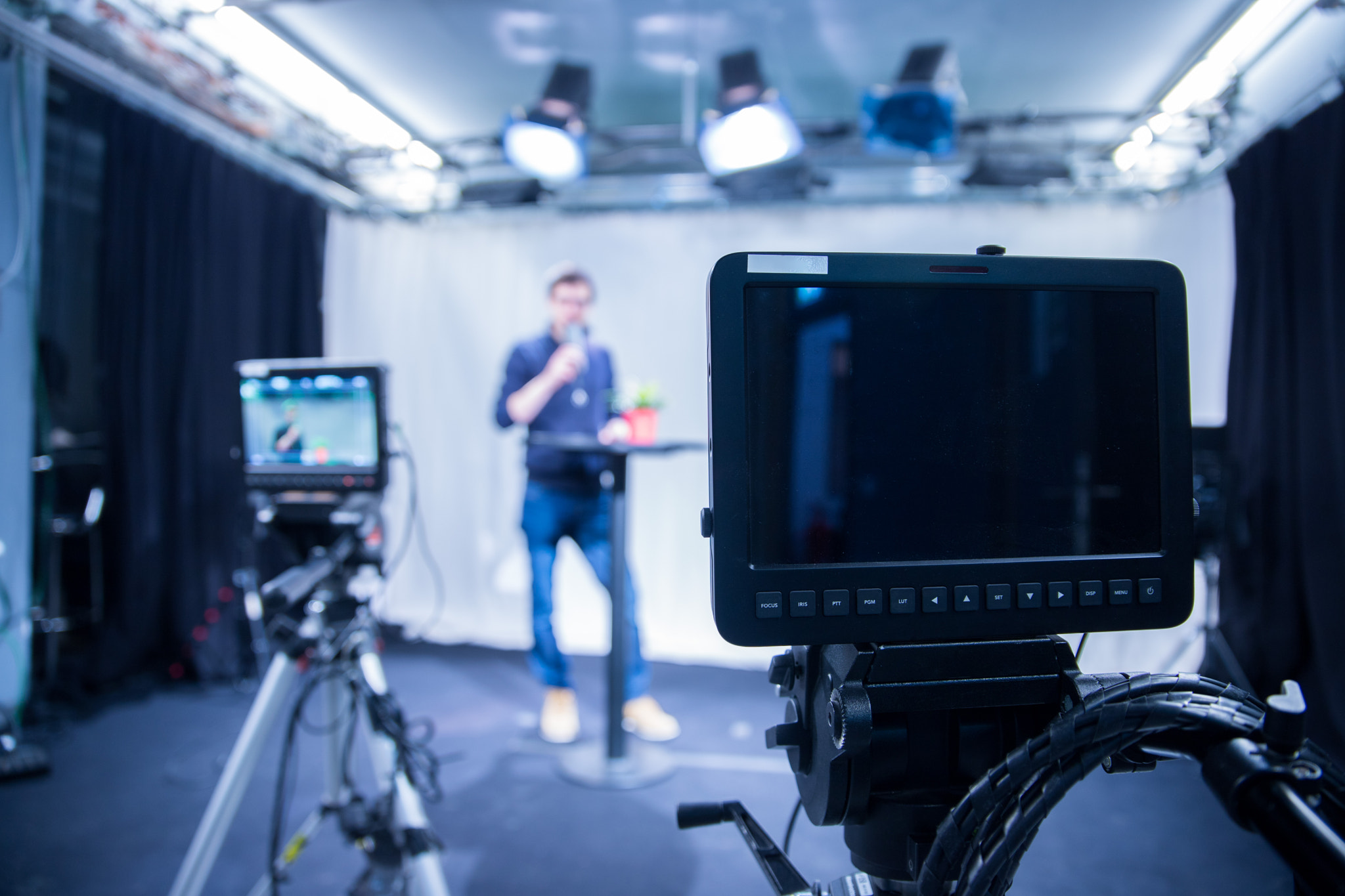 Journalist in a television studio is talking into a microphone,