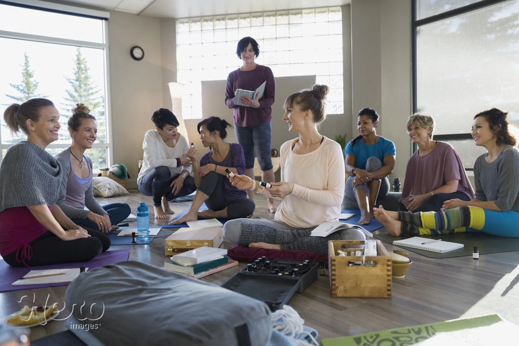 Instructor explaining essential oils at yoga retreat