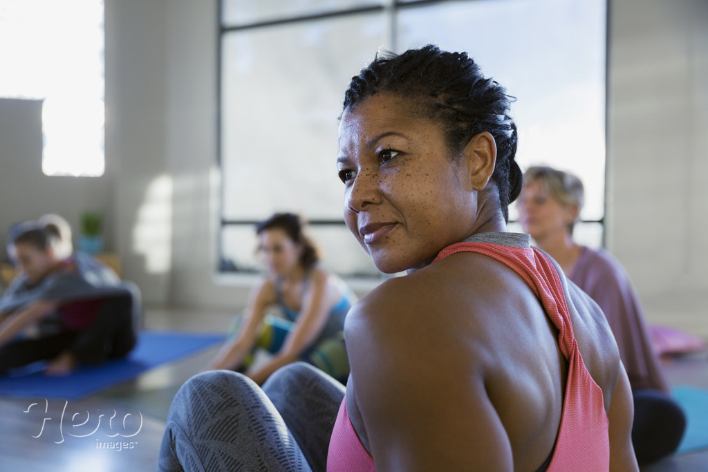 Attentive woman looking away in yoga class by Hero Images Hero Images on 500px.com