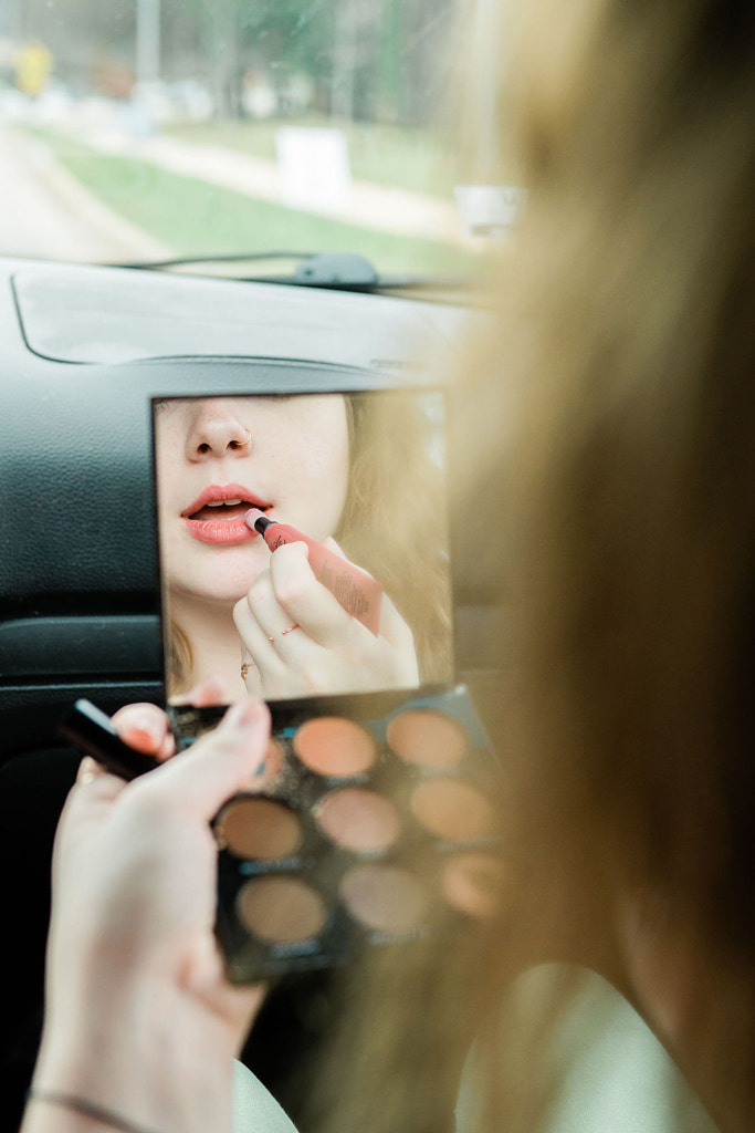 Woman getting ready while commuting by Jason Hampden on 500px.com