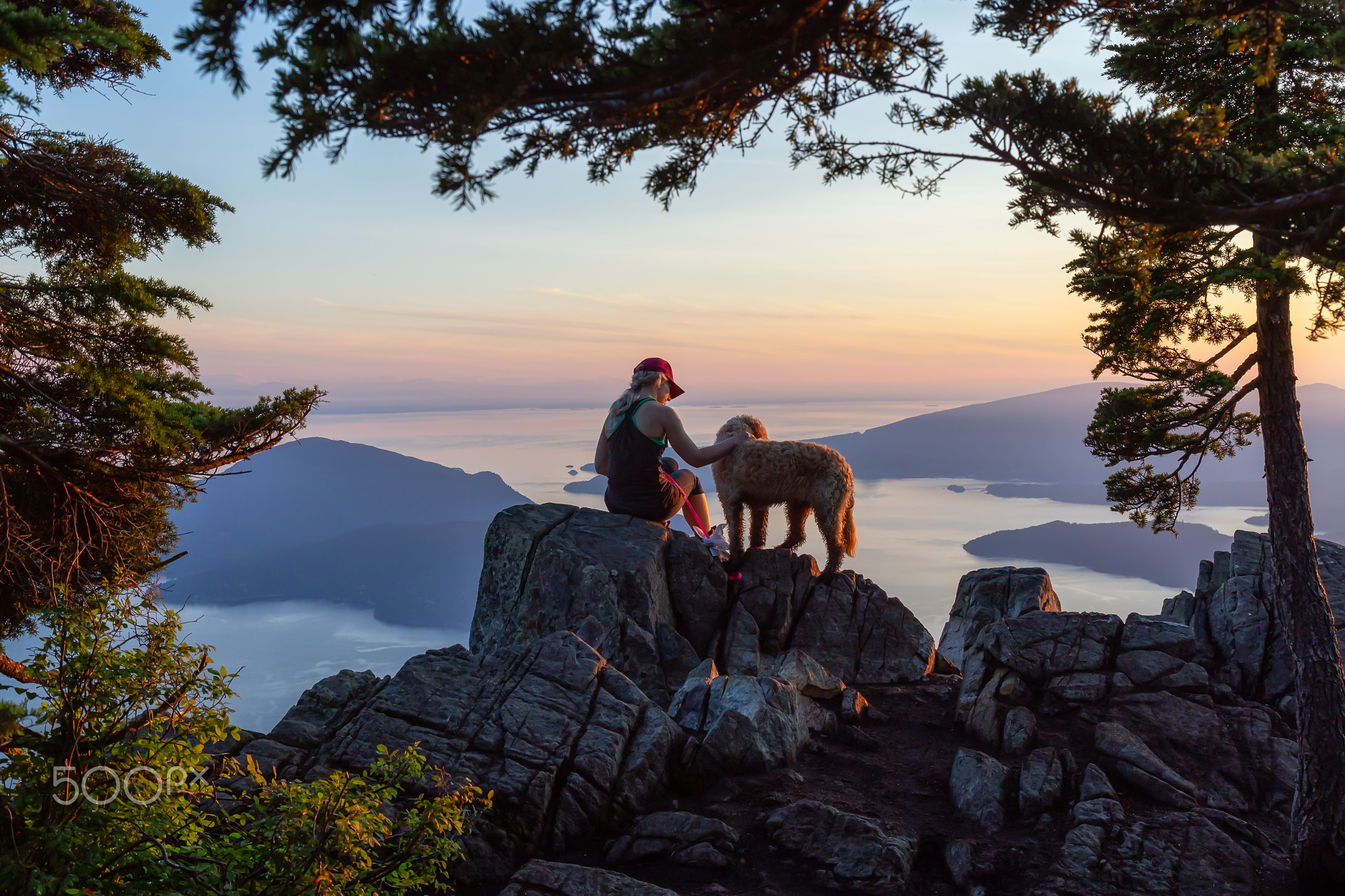 Adventurous Girl is hiking with a dog on top of St. Mark's Mountain