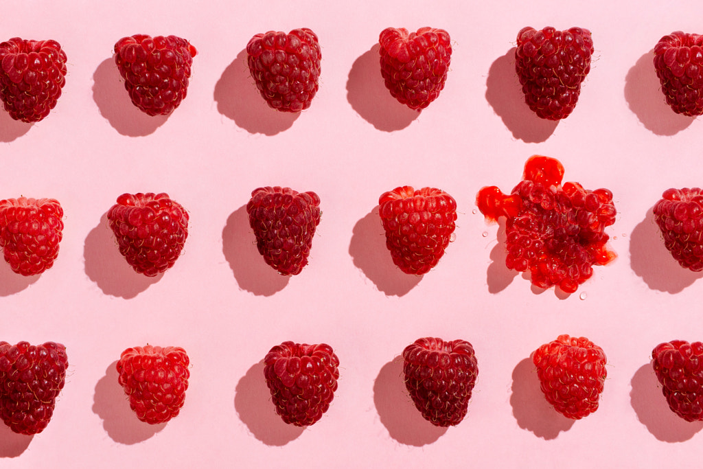 Flatlay of arranged raspberries on pink by Nataly Lavrenkova on 500px.com