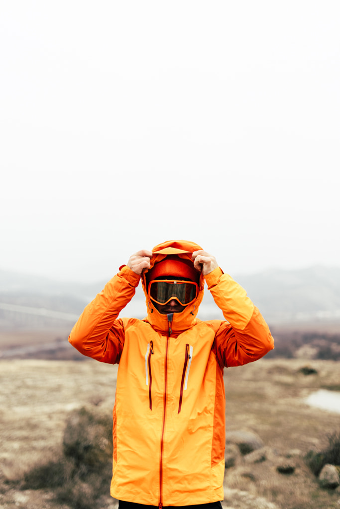 Young man in bright orange jacket hiking by Petar Tutundziev on 500px.com