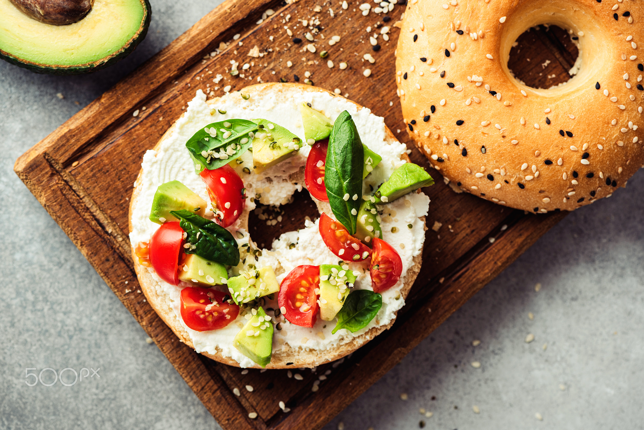 Bagel toast with avocado, cream cheese and tomatoes