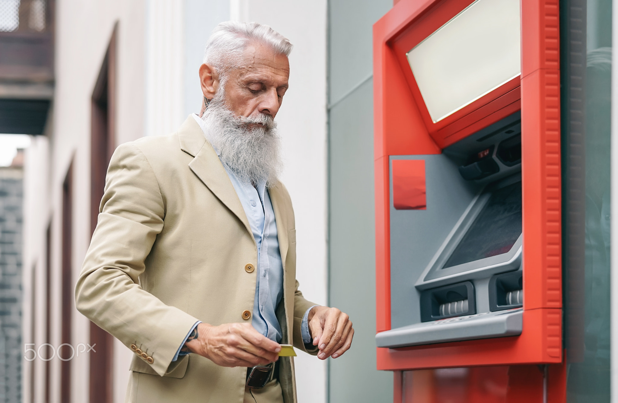 Senior man withdraw money from bank cash machine with debit card