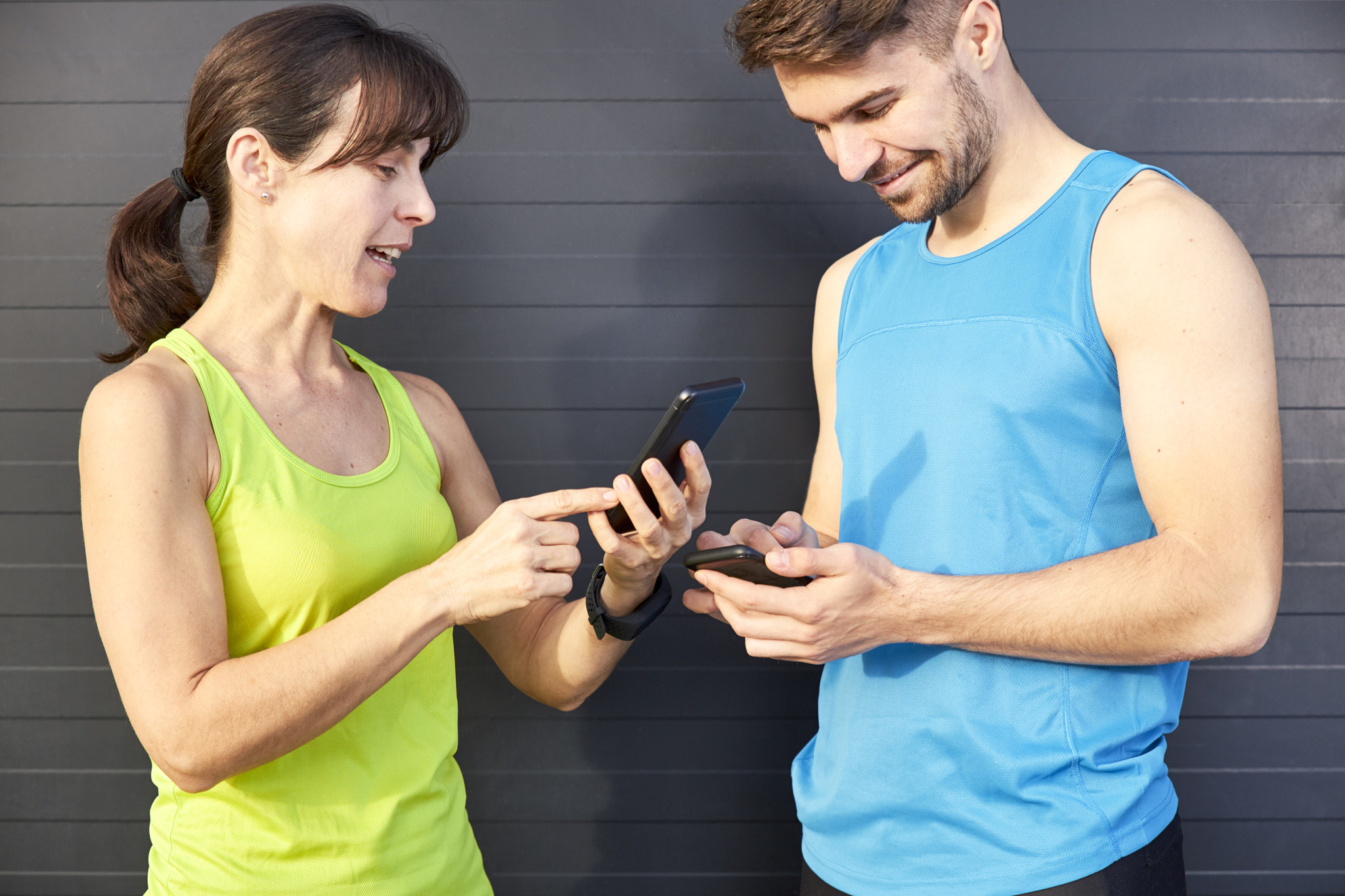man and woman looking at mobile after running. sport concept.
