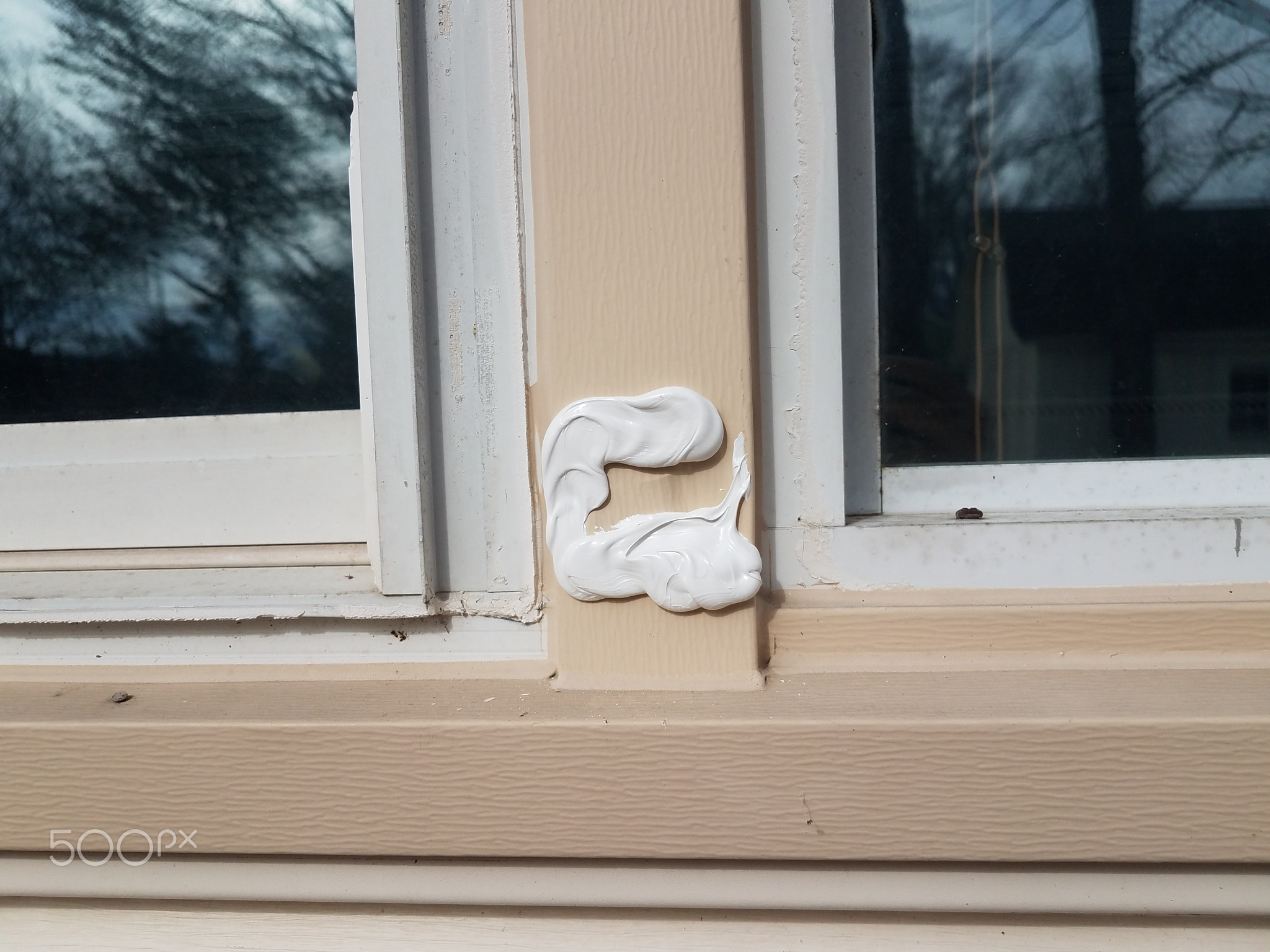 filled or repaired hole in damaged metal frame of window on house