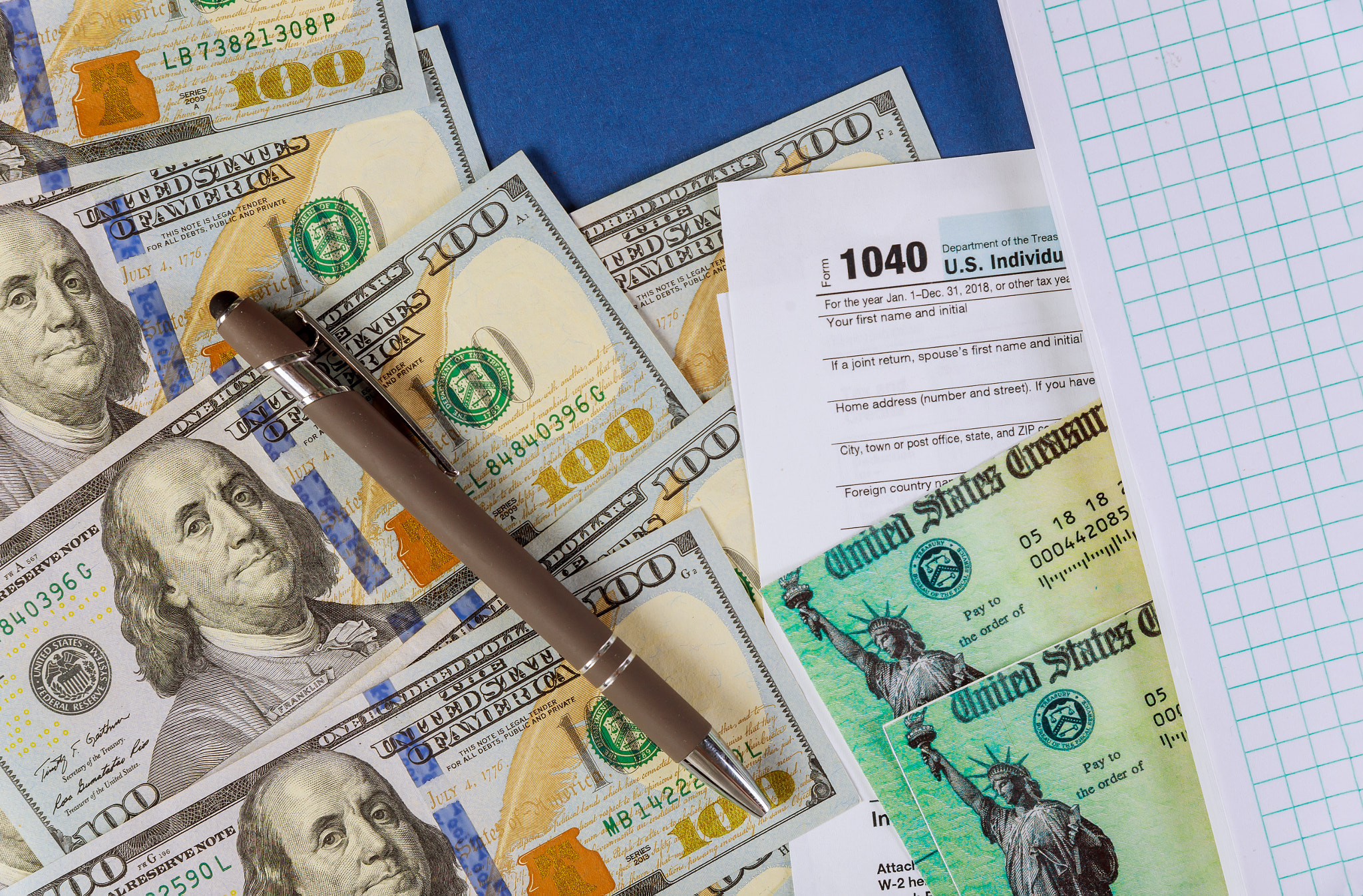 Form 1040 U.S. individual income tax return notepad dollar bills