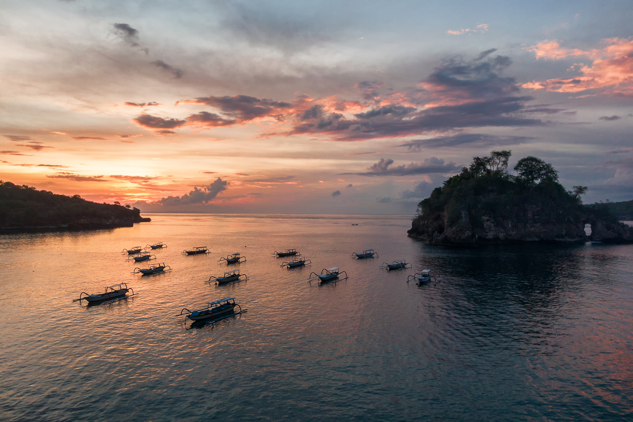 Longtail boats moored in Crystal Bay at sunset, Nusa Penida, Indonesia