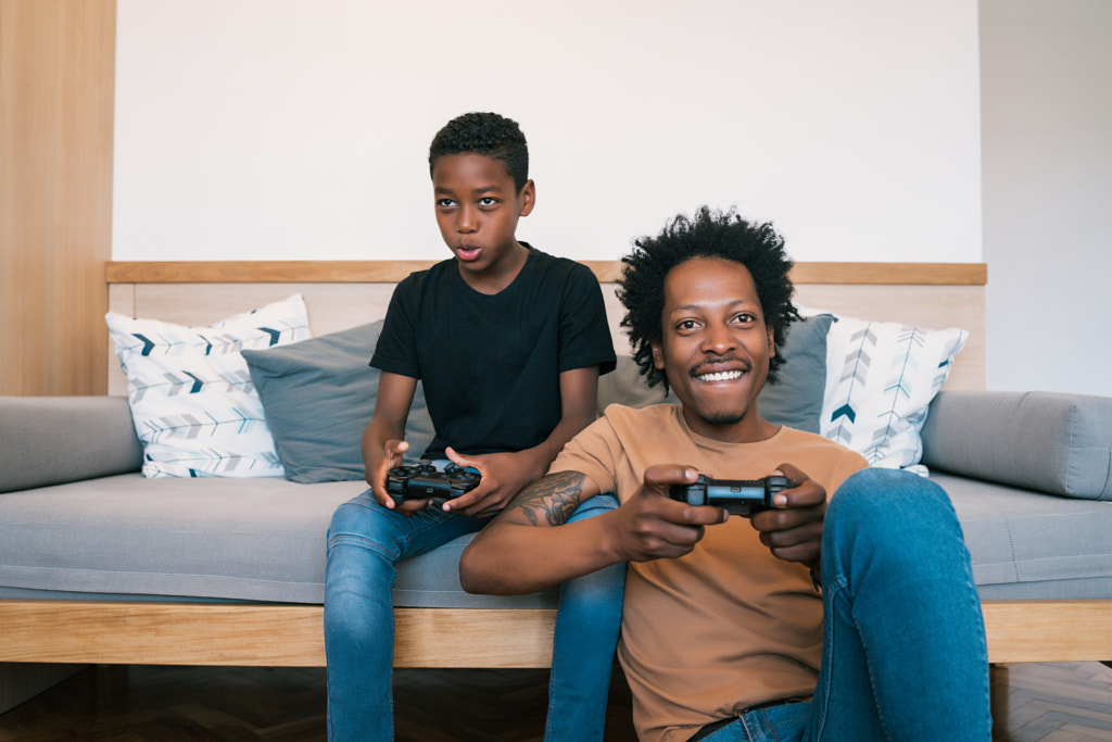 happy African American father and son playing console video games by Mego Studio on 500px.com