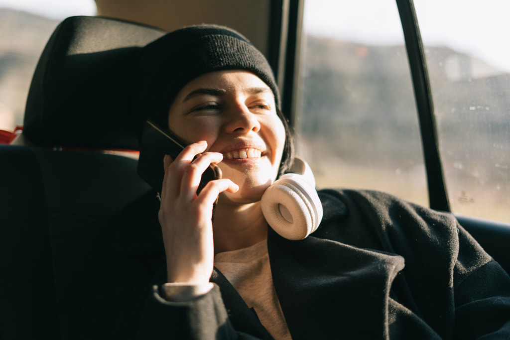 Young girl talking on a mobile phone while traveling by Petar Tutundziev on 500px.com