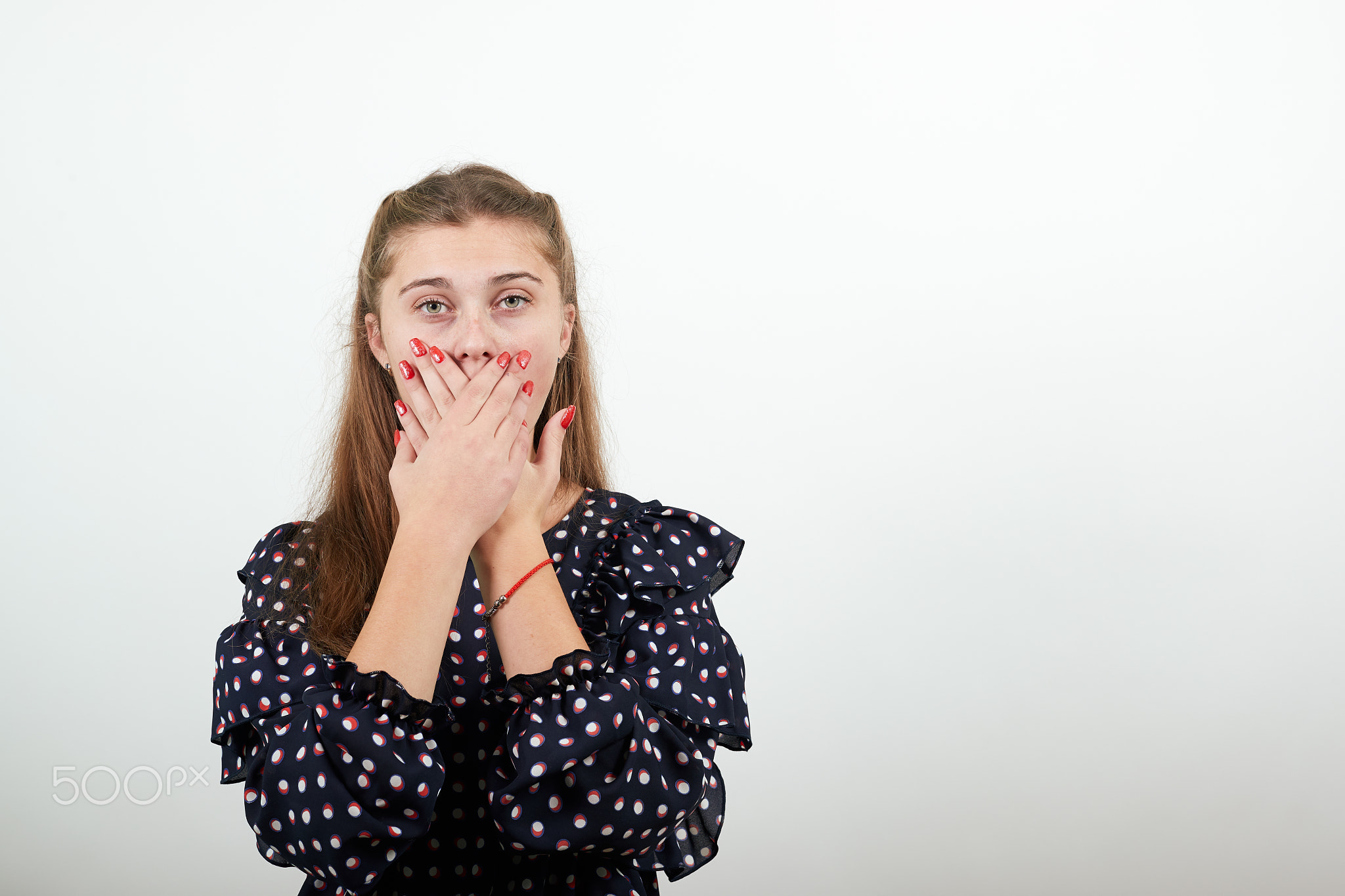 girl in a black dress woman shocked by surprise, covered mouth with