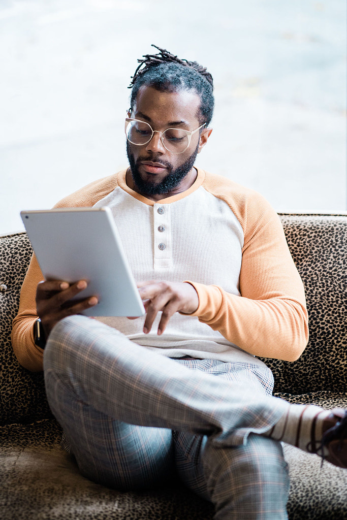 Young man using technology by Jason Hampden on 500px.com